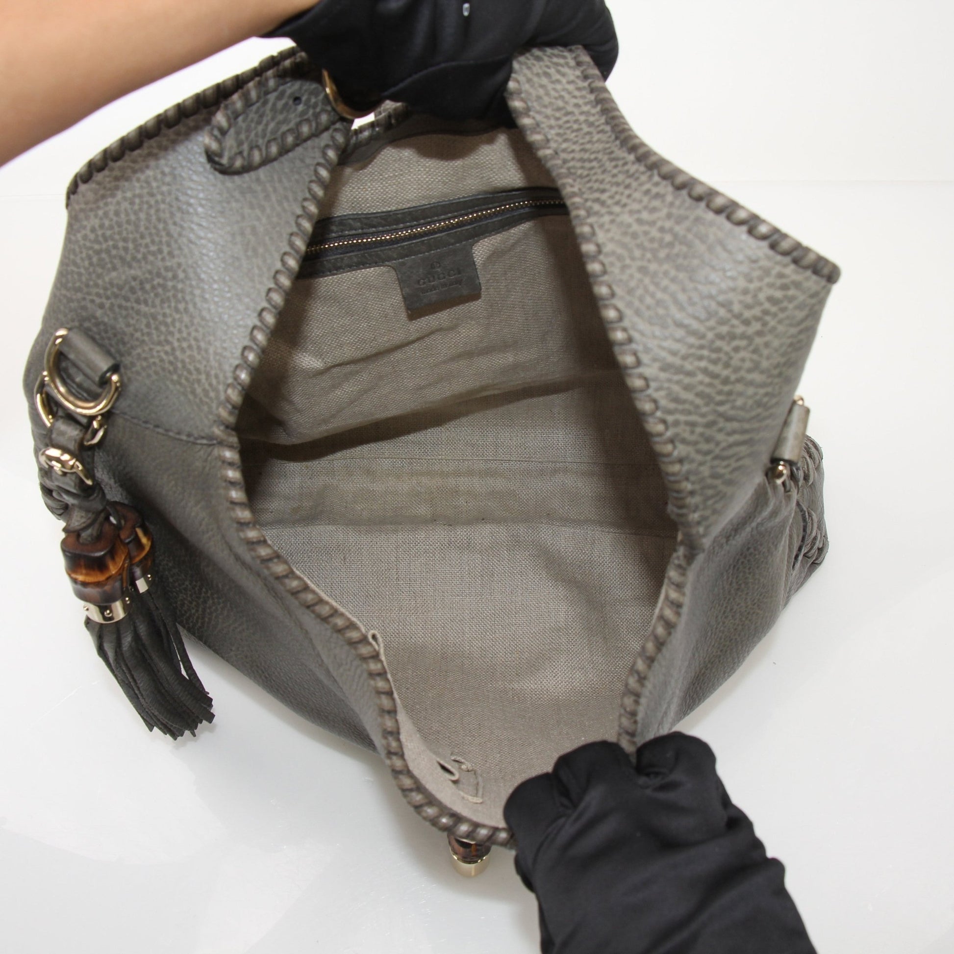 Gucci Pebbled Calfskin Jackie Shoulder Bag with gold hardware and adjustable strap, featuring classic design and textured leather.