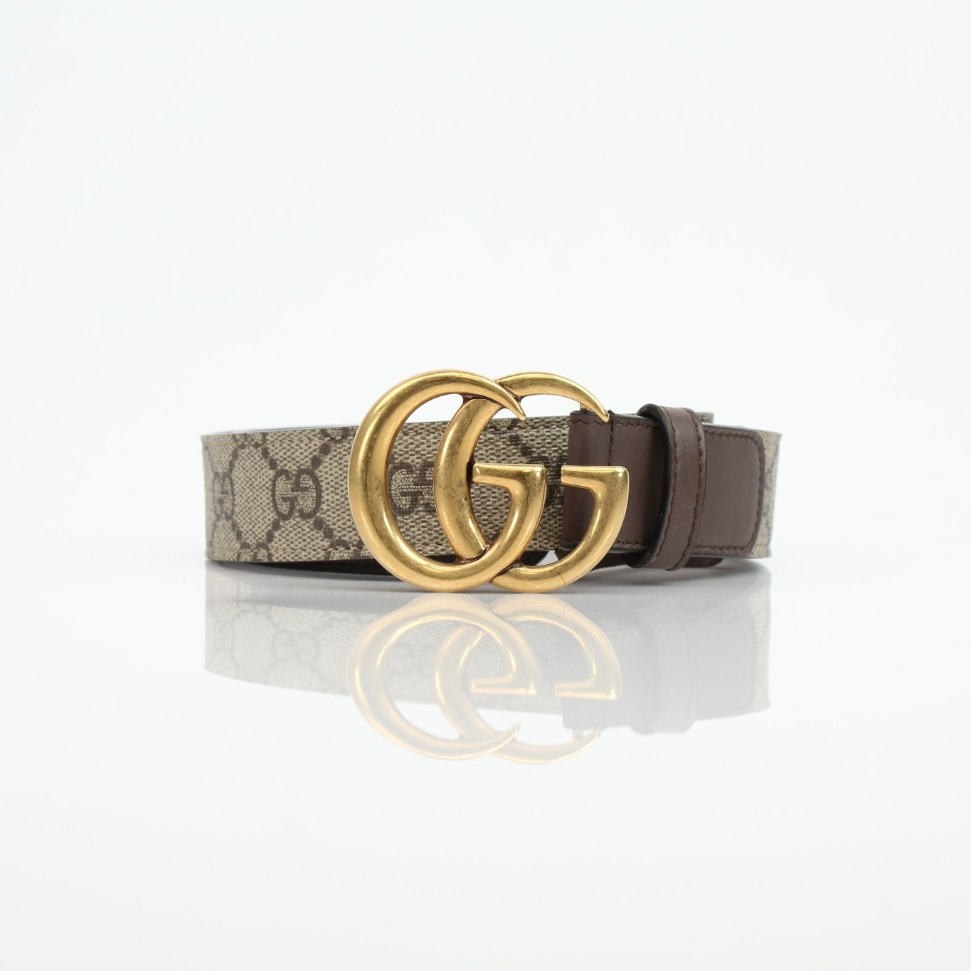 Gucci GG Supreme Double G belt showing the iconic monogram pattern and double G logo buckle on a brown leather strap.