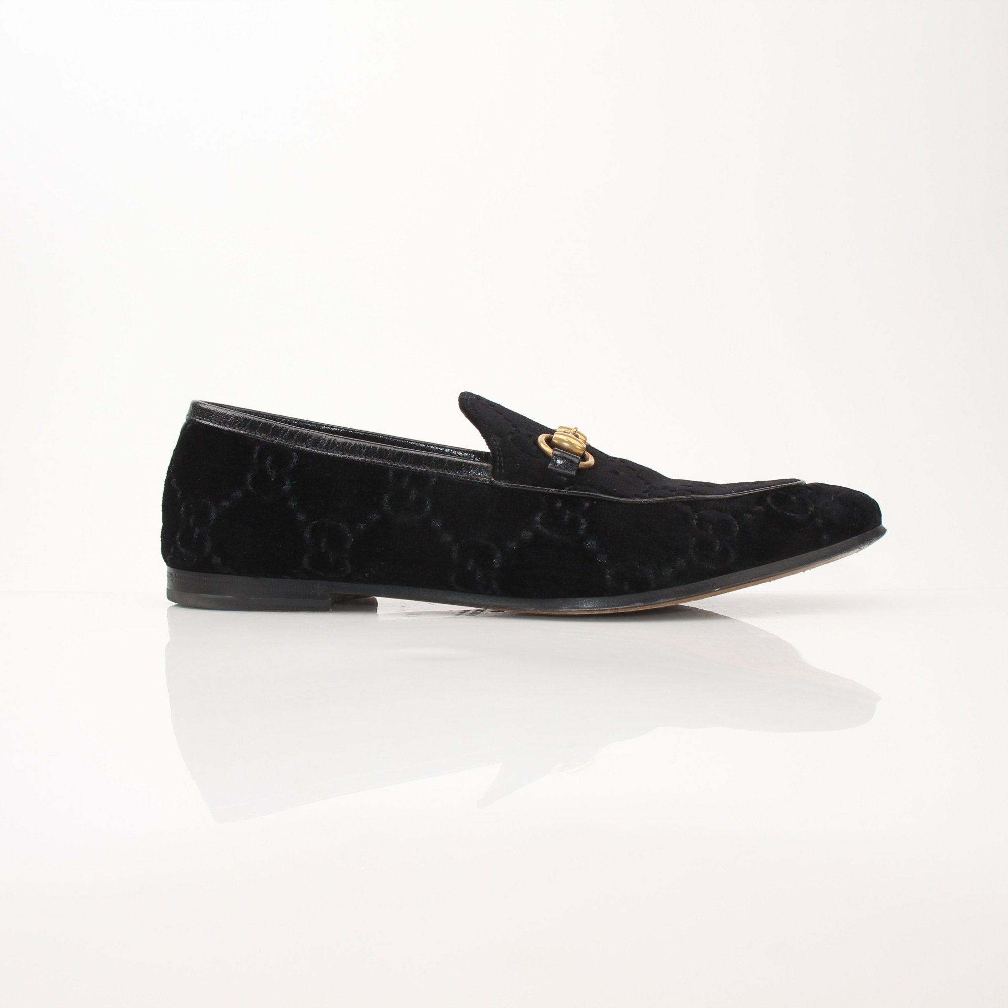Gucci Men’s Jordaan GG black velvet loafers, stylish slip-on shoes with signature design, on a plain background.