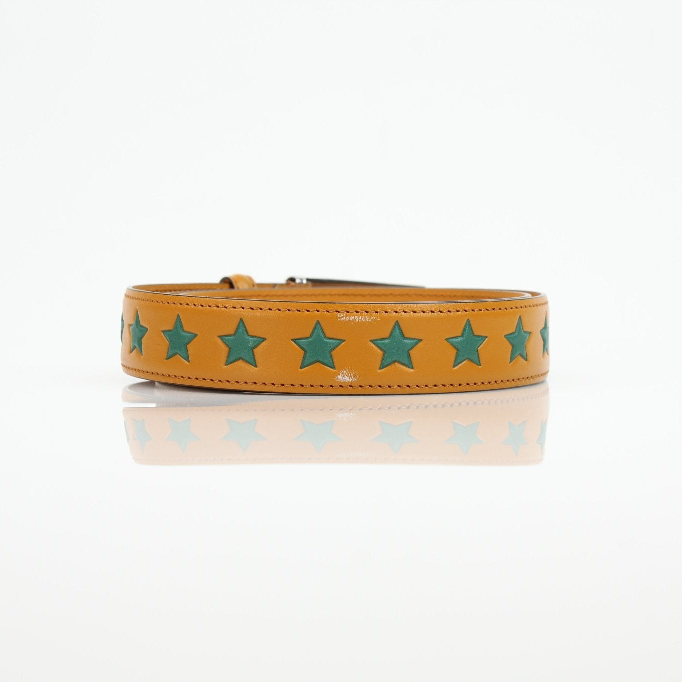 Golden yellow Gucci star leather belt from Gold & Beyond accessories collection, featuring a star-shaped buckle.