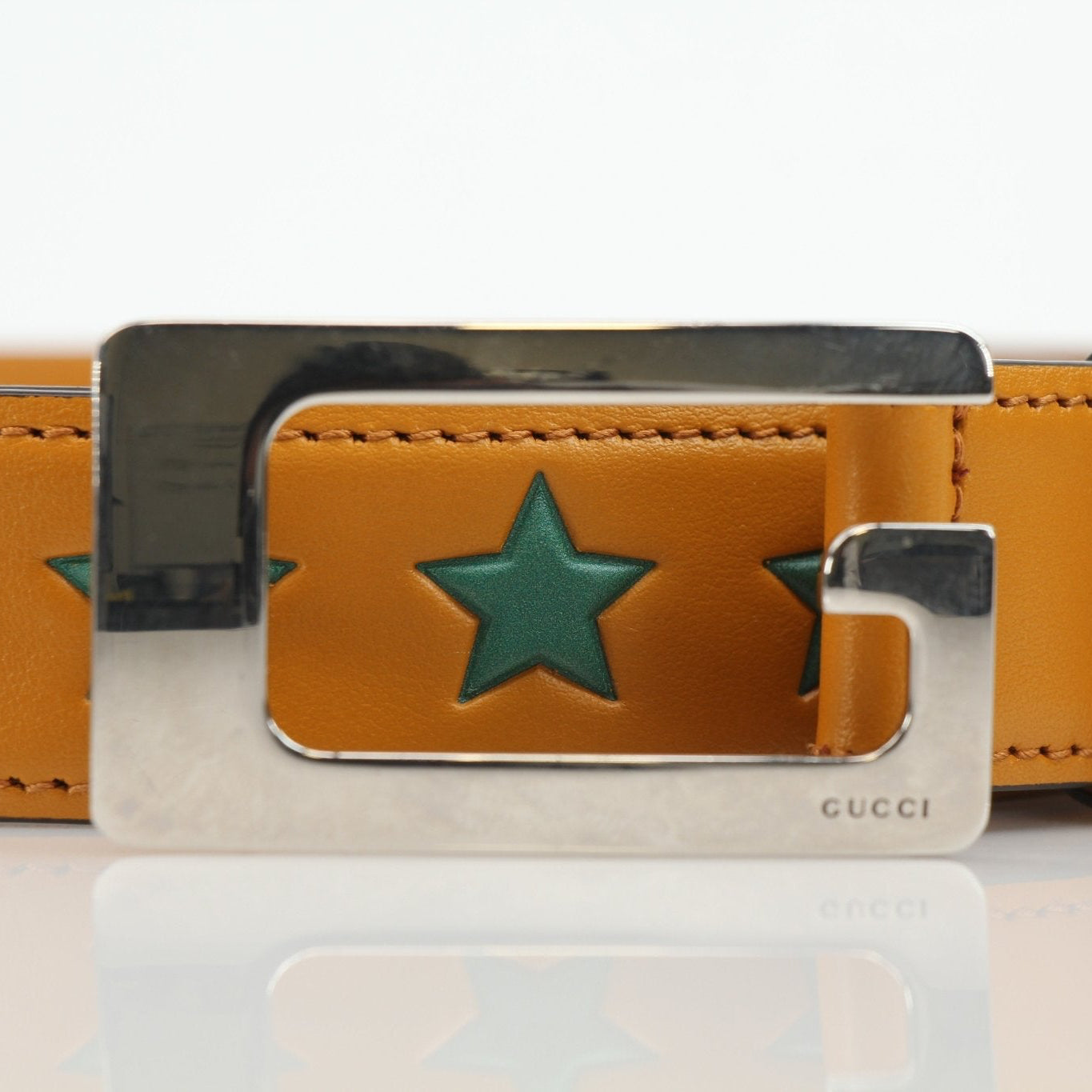 Gold & Beyond yellow leather belt with star-shaped buckle, stylish accessories for fashion-forward outfits.
