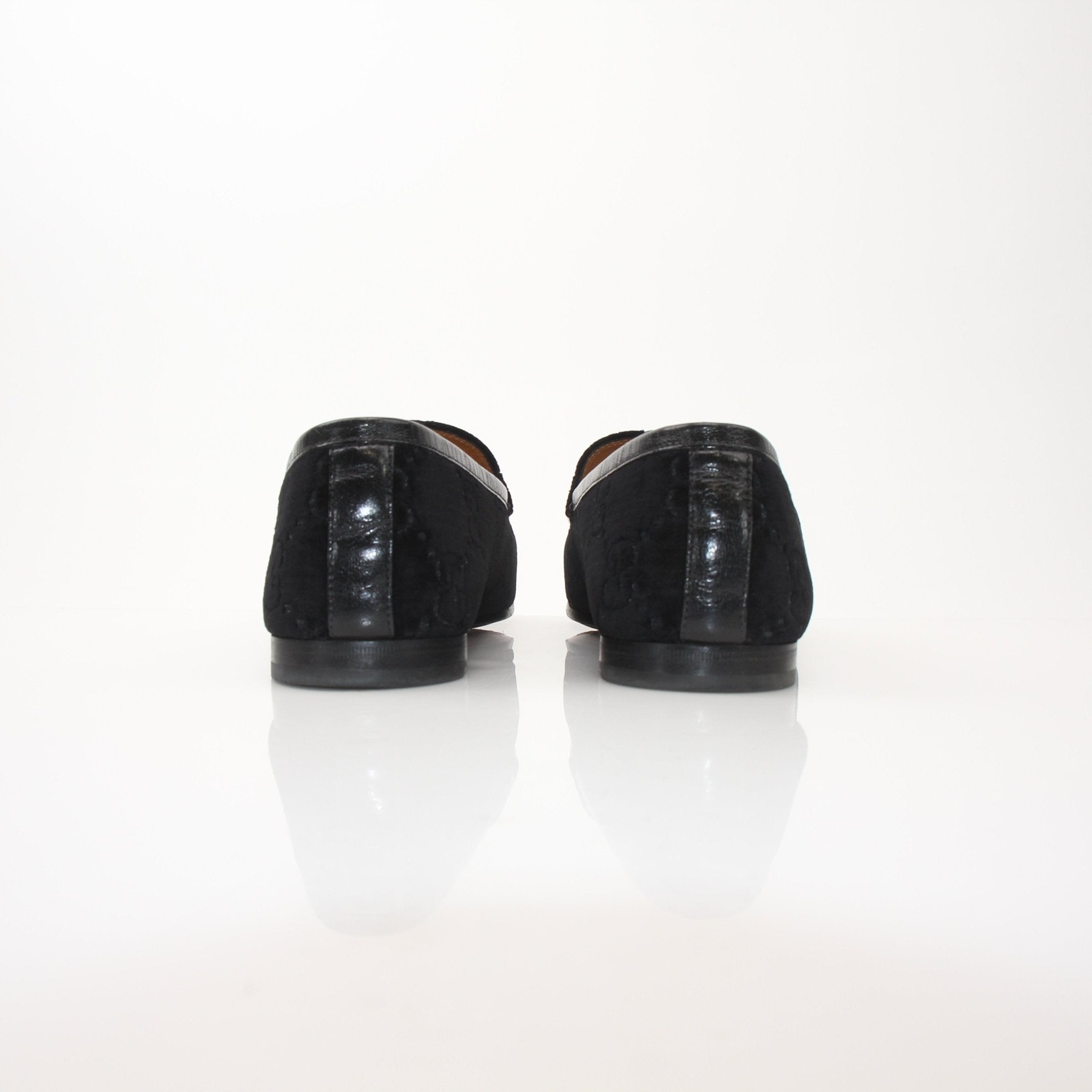 Gucci Men’s Jordaan GG black velvet loafers featuring the signature Gucci monogram and sleek slip-on shoe design.