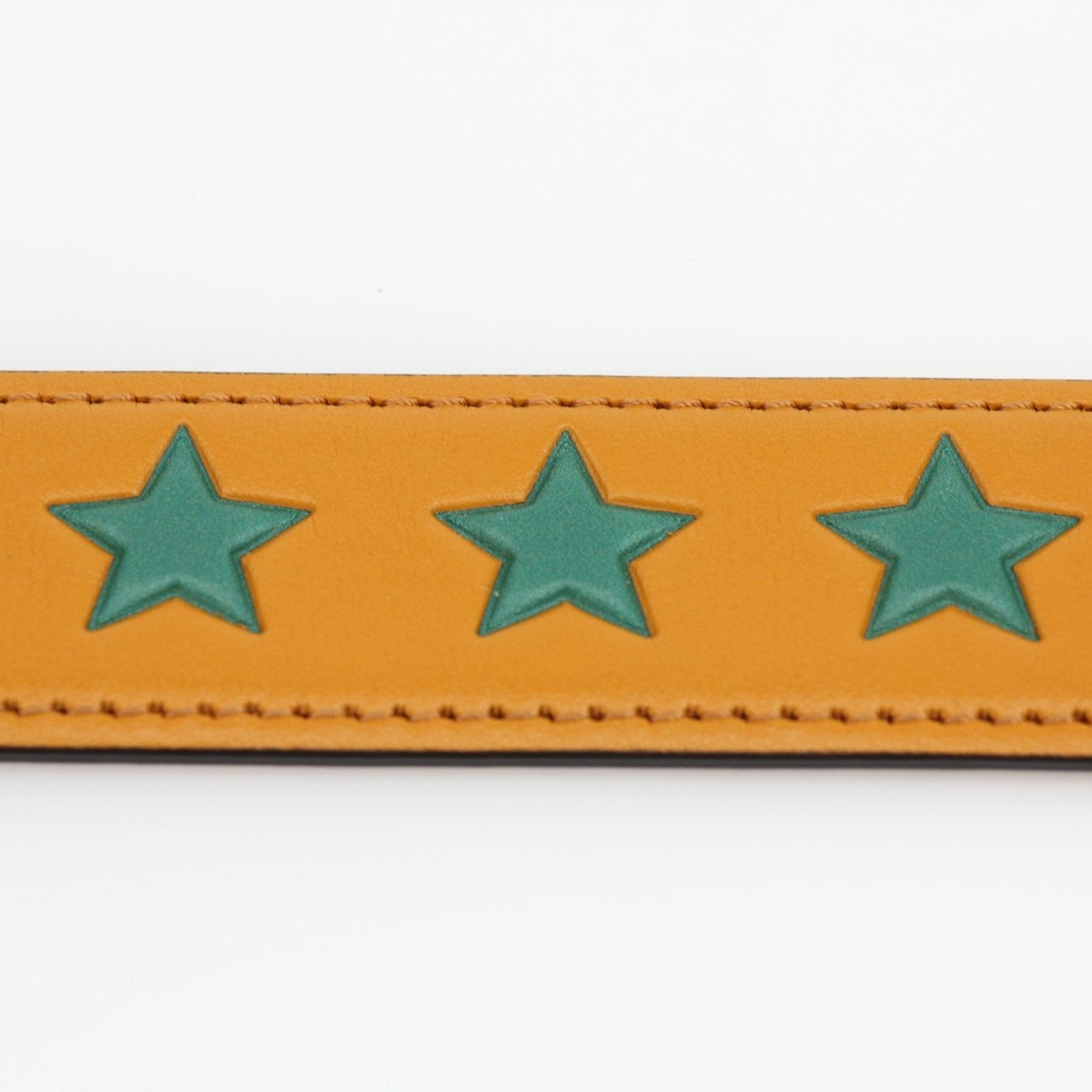 Gucci yellow star leather belt from Gold & Beyond accessories collection, featuring a star design and adjustable buckle.