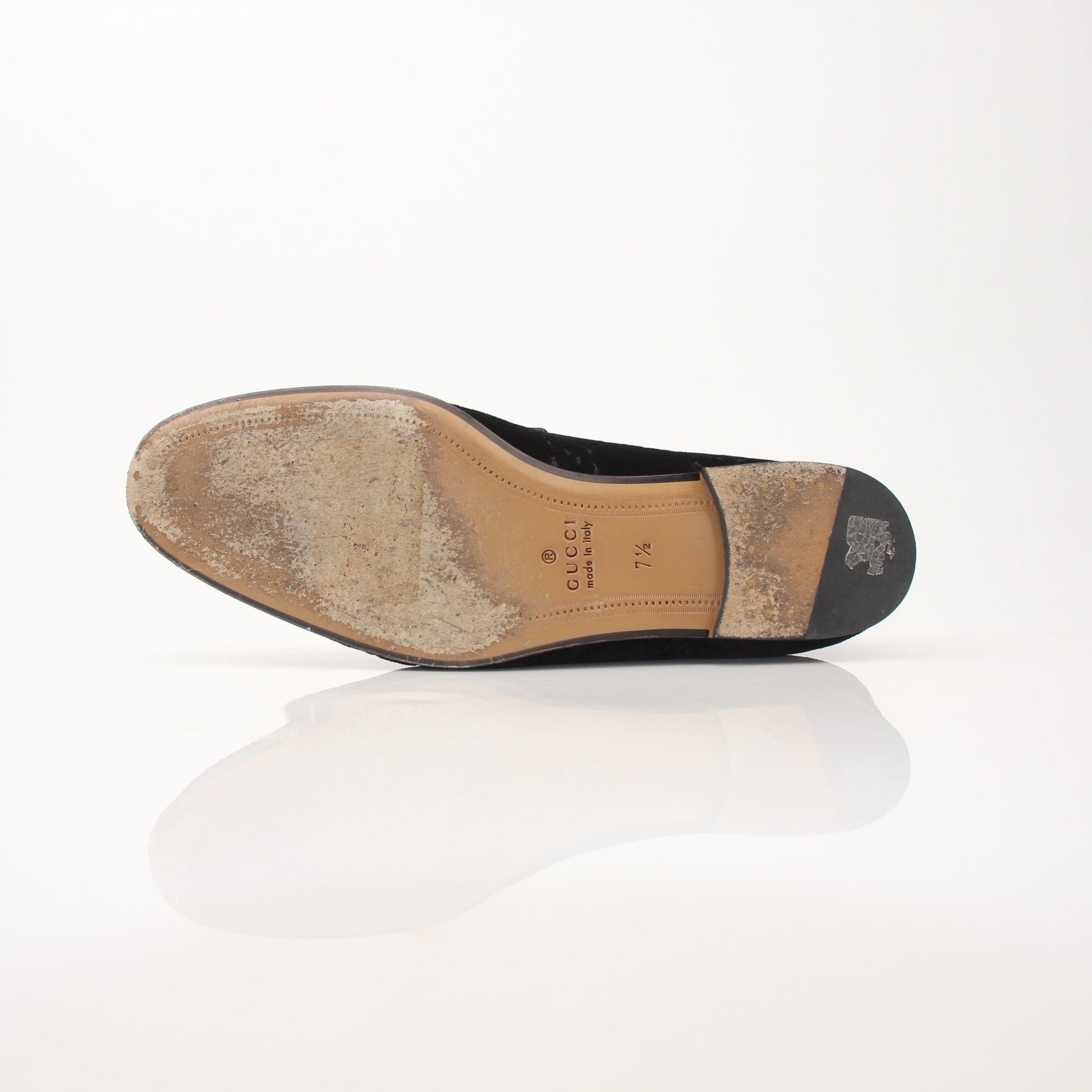 Gucci Men’s Jordaan GG black velvet loafers, stylish slip-on shoes with gold branding, on a white background.