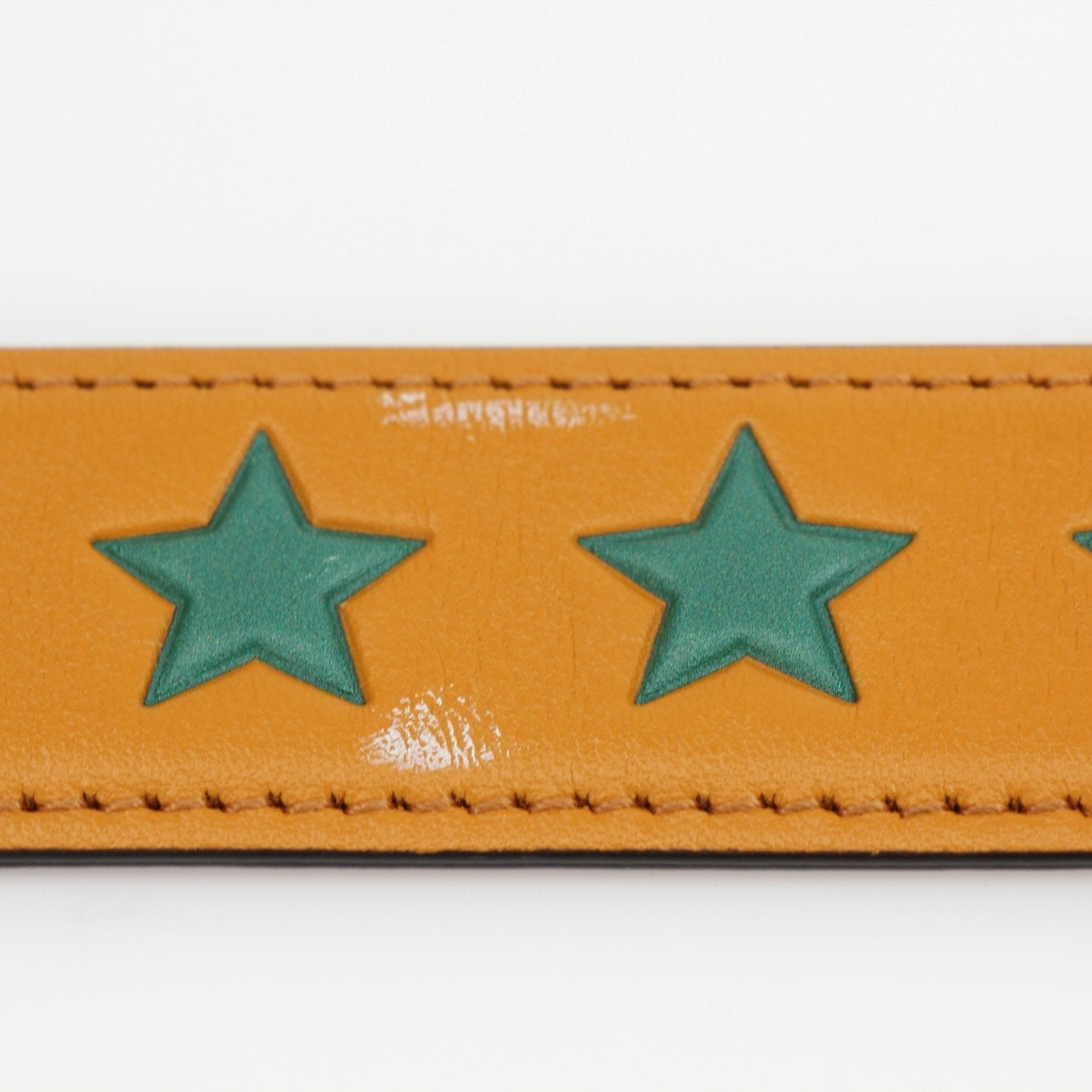 Yellow star leather belt from Gucci, stylish accessories with gold accents and adjustable strap, perfect for fashion-forward outfits.