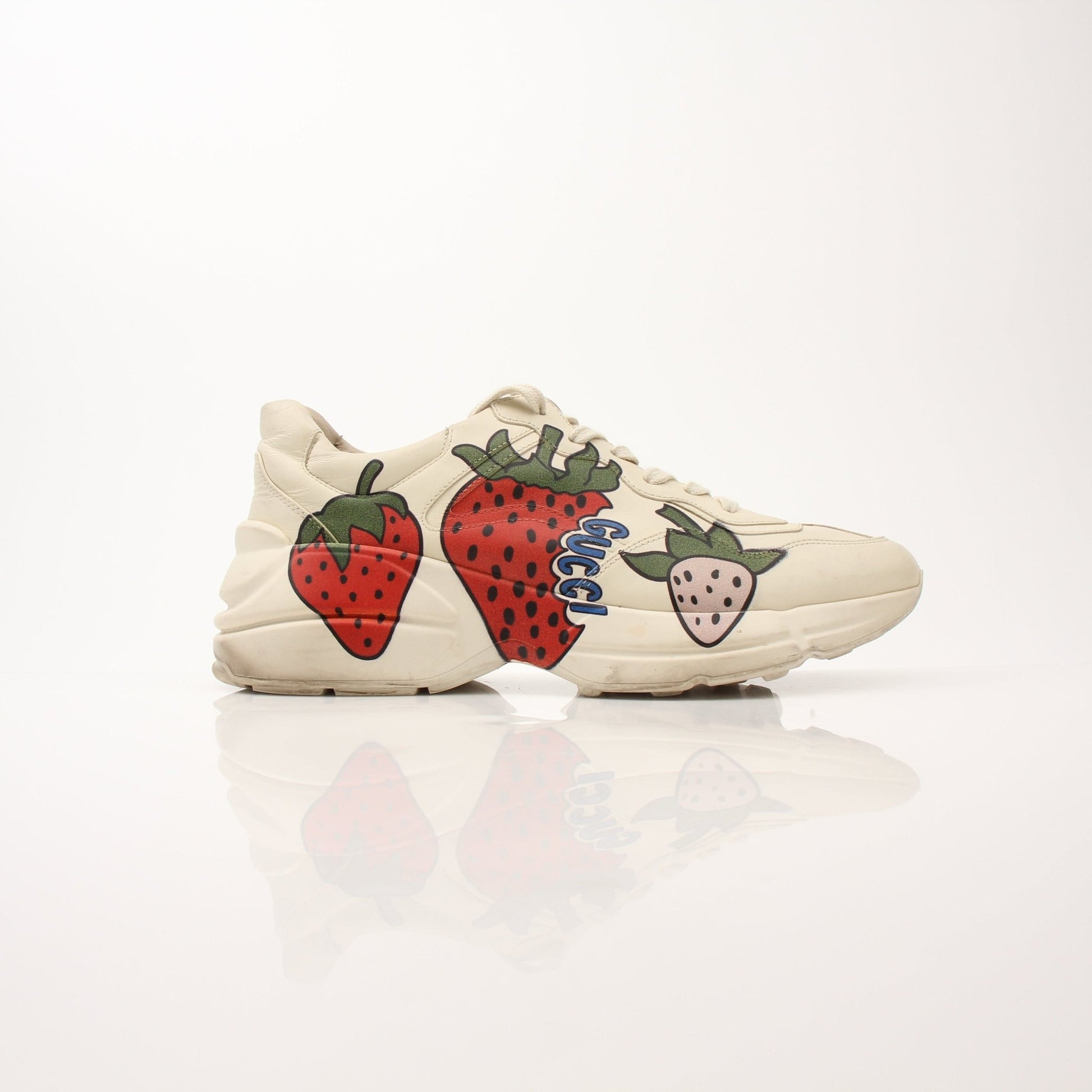 Gucci Women's Rhyton Strawberry Sneakers with white leather and red strawberry embroidery, stylish casual shoes by Gold & Beyond.