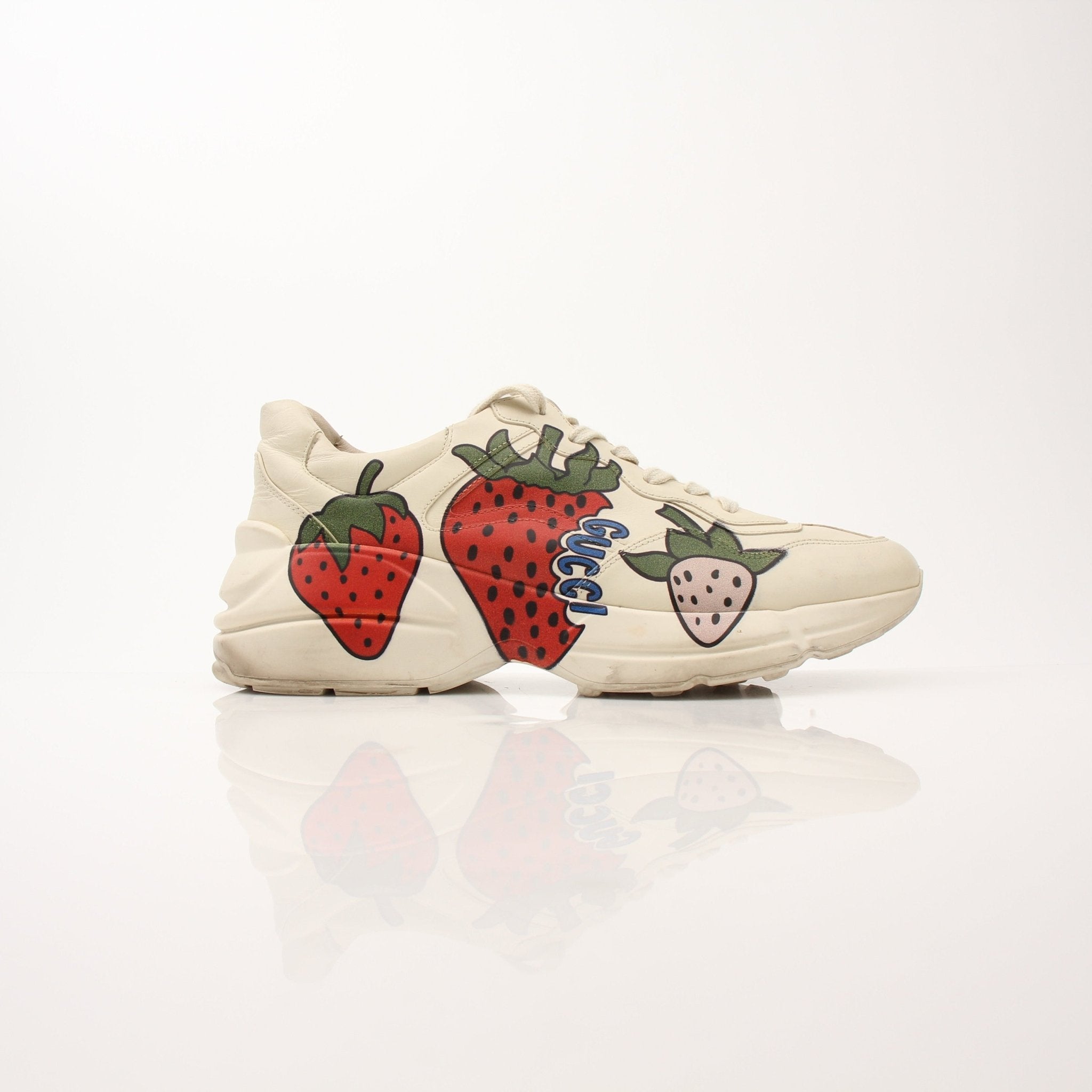 Gucci Women's Rhyton Strawberry Sneakers with white leather and red strawberry embroidery, stylish casual shoes by Gold & Beyond.