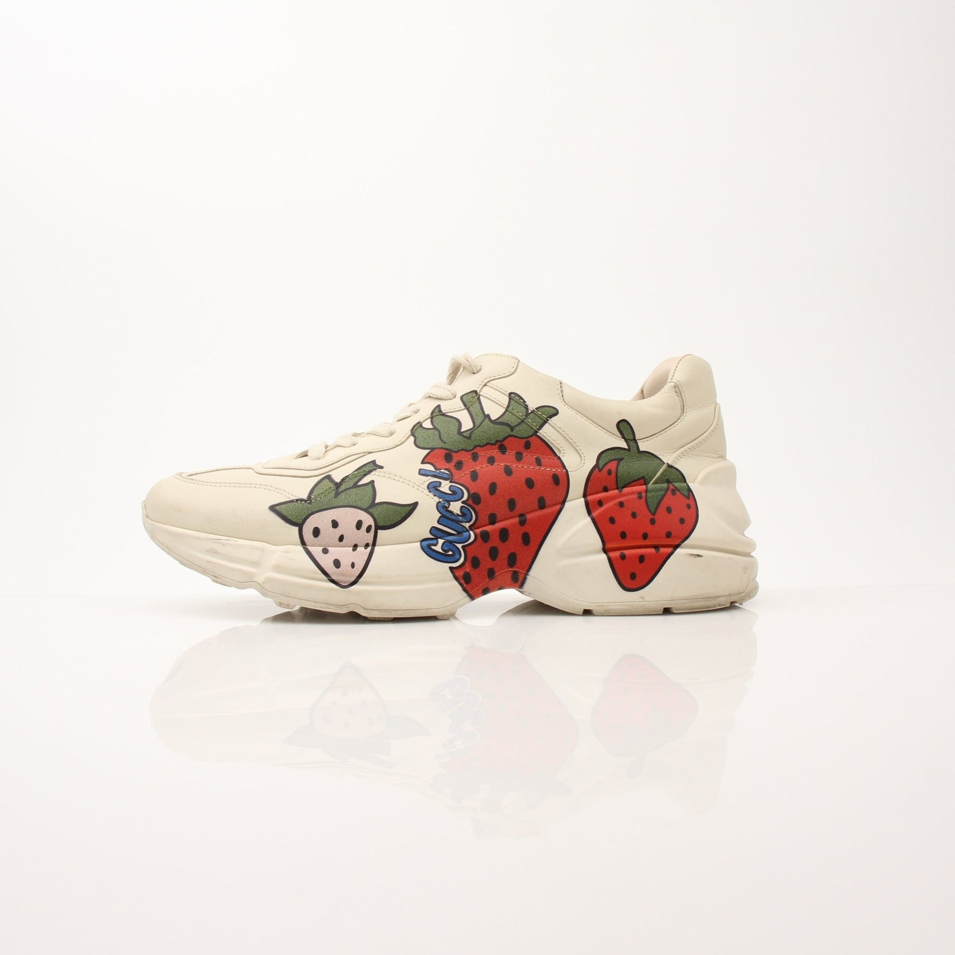 Gold & Beyond Gucci Women’s Rhyton Strawberry Sneakers with white soles and red strawberry design, casual sporty shoes.