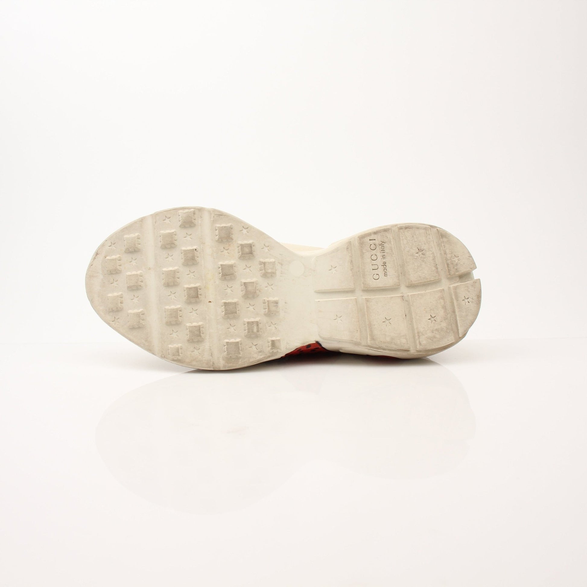 Gucci Women’s Rhyton Strawberry Sneakers featuring white leather, red strawberry design, and Gucci branding on the shoes.