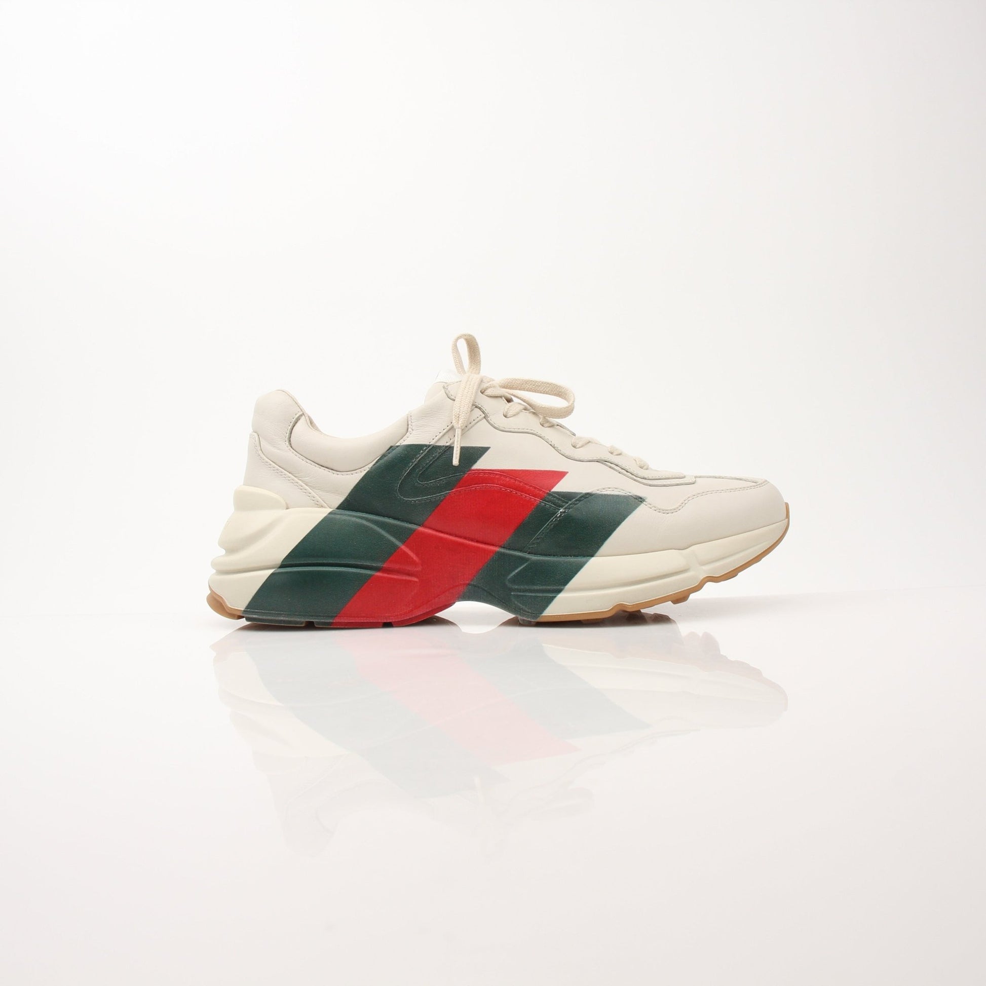 Gucci men's Rhyton Web print sneakers with white and green design, showcasing stylish canvas shoes with brand logo accents.