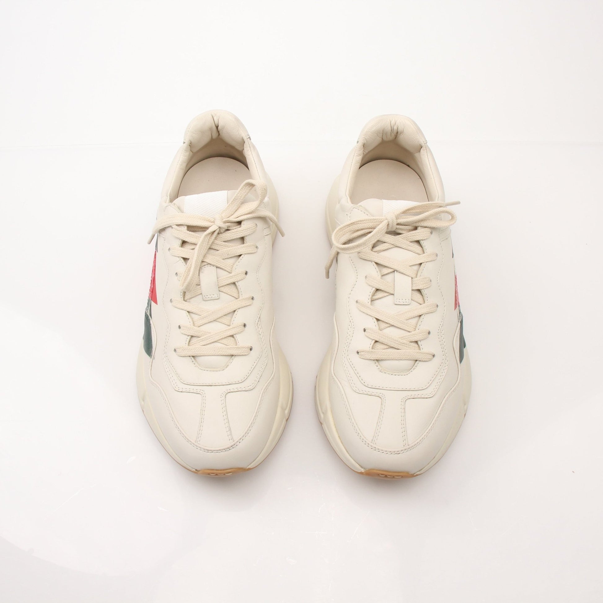 Gold & Beyond Gucci Men’s Rhyton Web Print Sneakers showing stylish sneakers with web print design on the shoes.