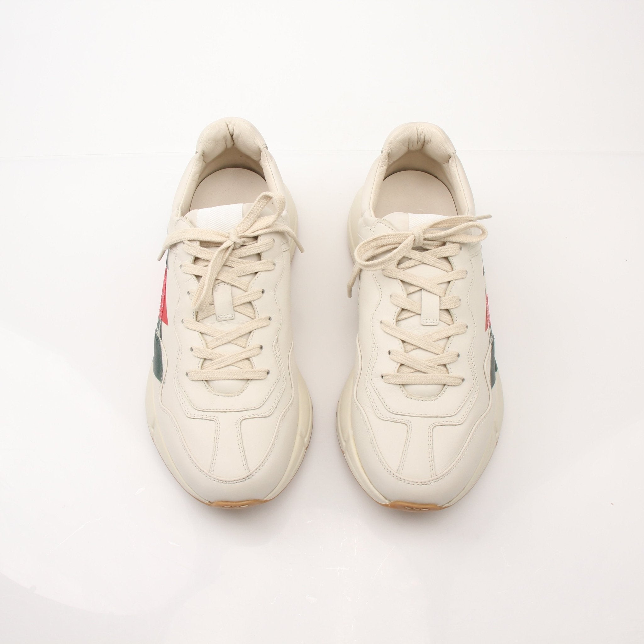 Gold & Beyond Gucci Men’s Rhyton Web Print Sneakers showing stylish sneakers with web print design on the shoes.