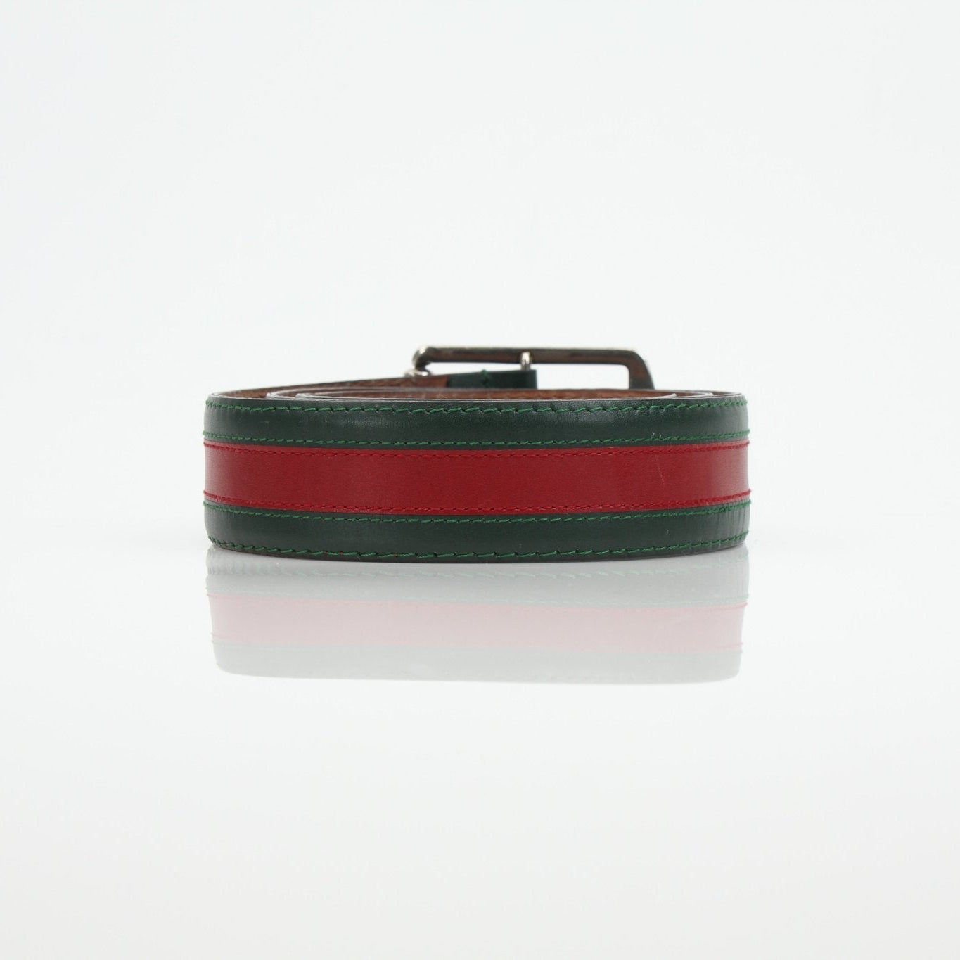 Gucci red and green web belt with gold accents, accessory showing the iconic branded design and sturdy buckle detail.