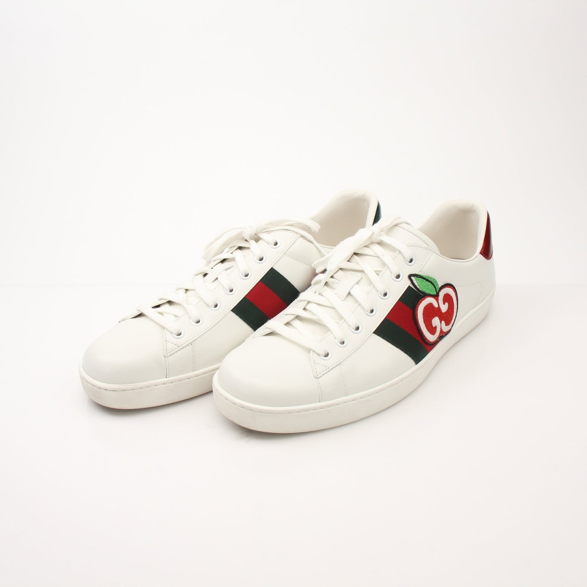 Gold & Beyond Gucci Men’s GG Apple Sneakers, stylish shoes with signature Gucci design and green-red-green stripe detail.