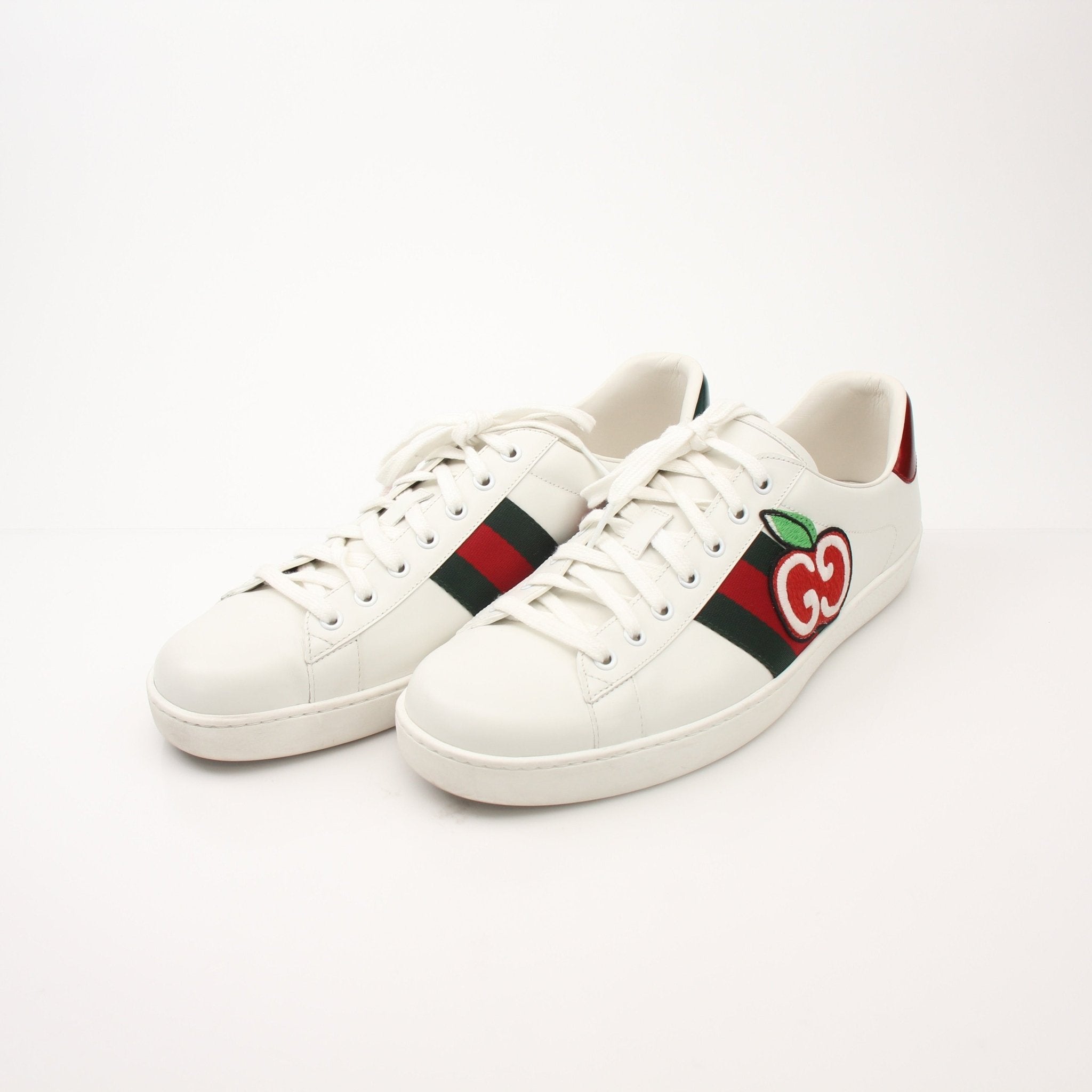 Gold & Beyond Gucci Men’s GG Apple Sneakers, stylish shoes with signature Gucci design and green-red-green stripe detail.