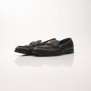 Gold & Beyond Gucci women’s double G loafers, stylish leather shoes with iconic logo details, shown on a clean background.