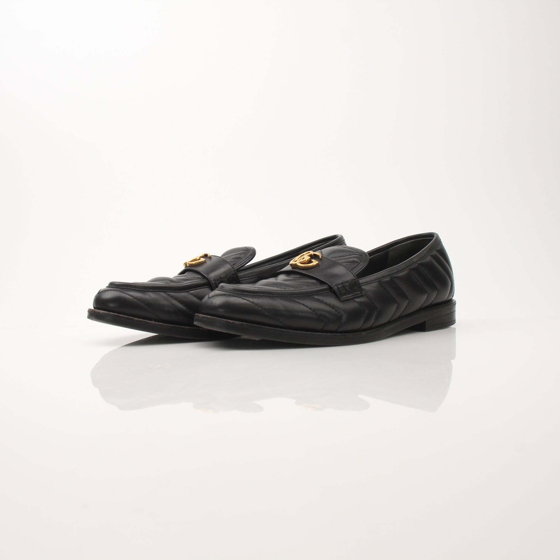 Gold & Beyond Gucci women’s double G loafers, stylish leather shoes with iconic logo details, shown on a clean background.
