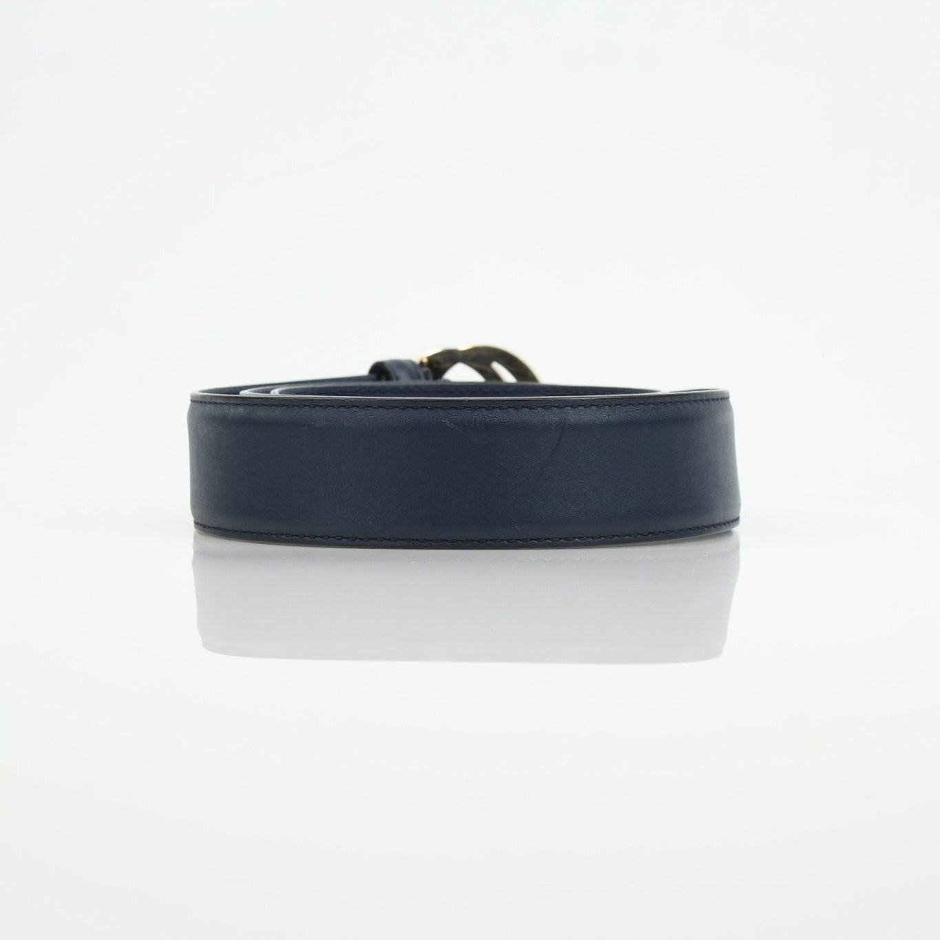Gucci navy interlocking GG belt with gold buckle, stylish accessories for fashion-forward outfits.