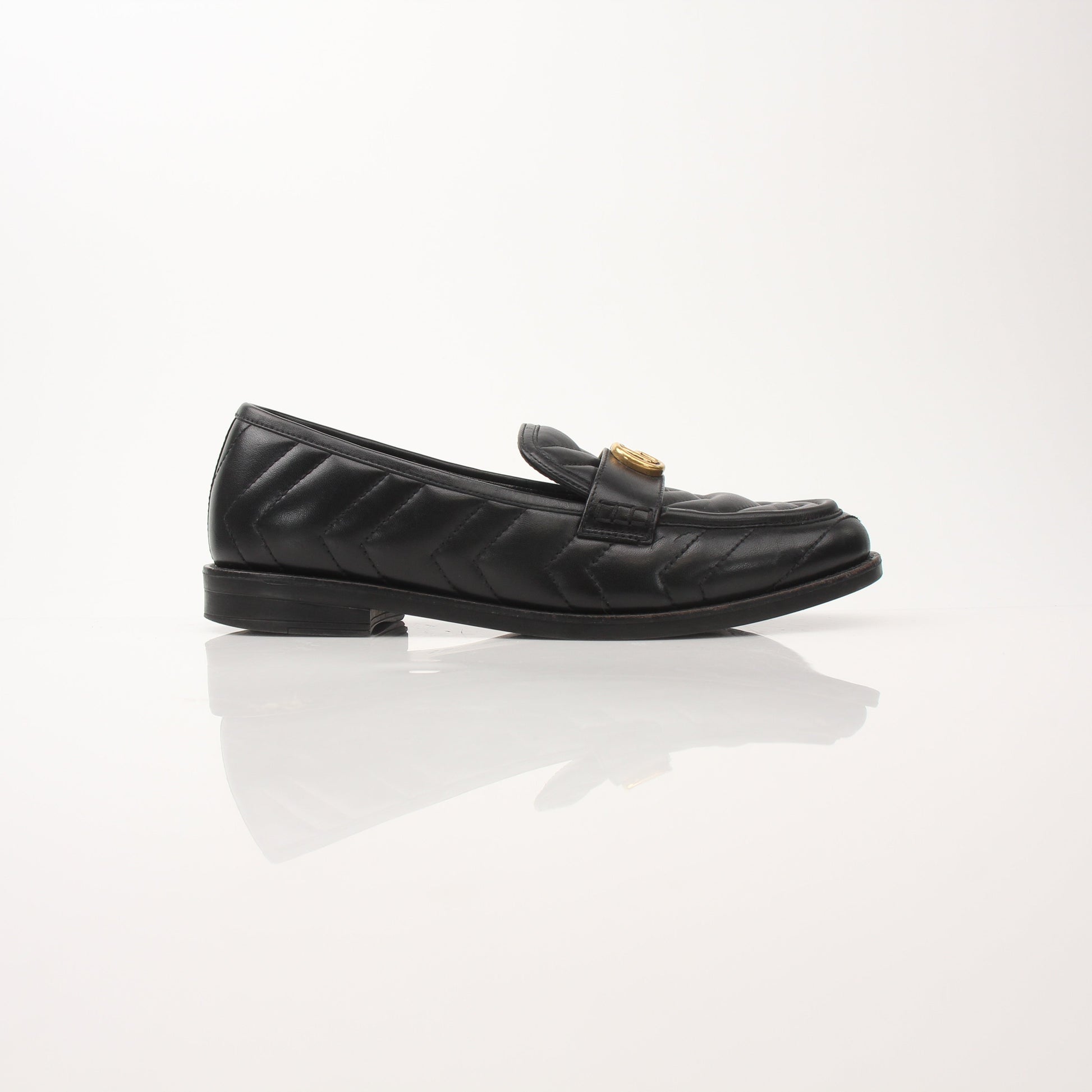 Gold & Beyond Gucci women's double G loafers, stylish leather shoes with signature hardware and classic design.