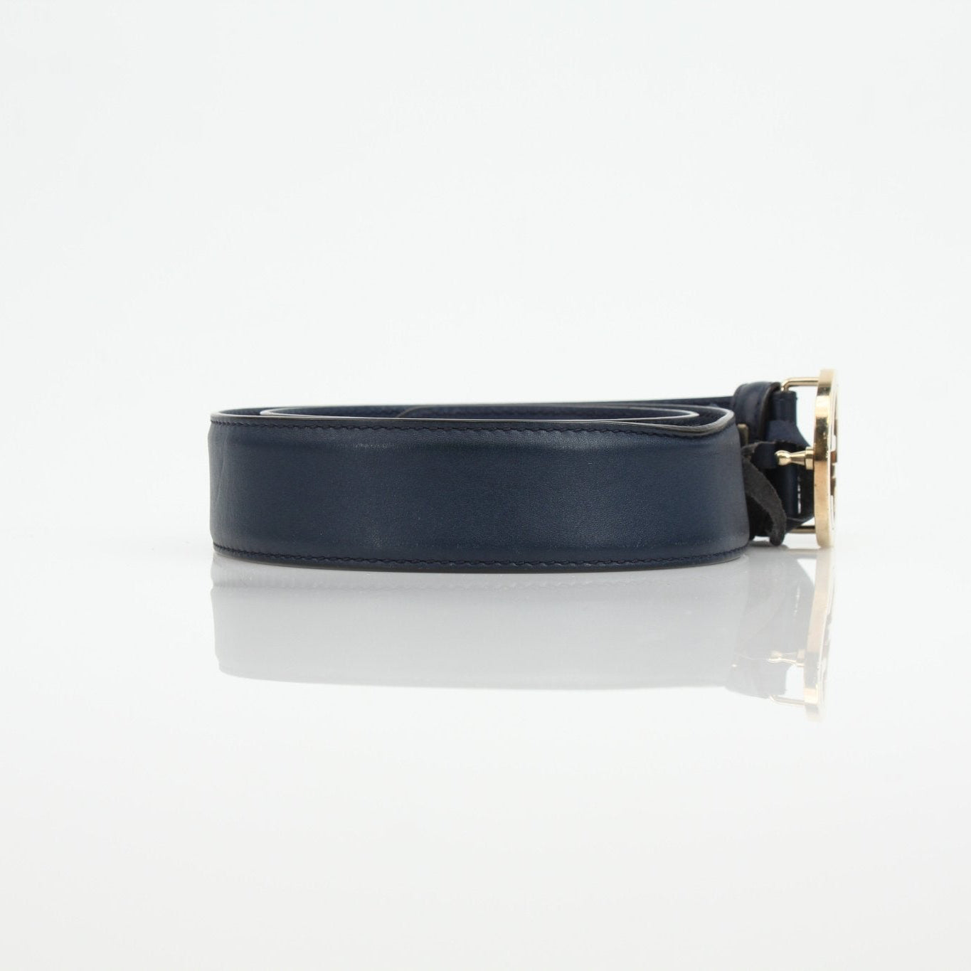 Gucci navy interlocking GG belt, luxury accessory with gold buckle, stylish and high-quality fashion belt shown in the image.