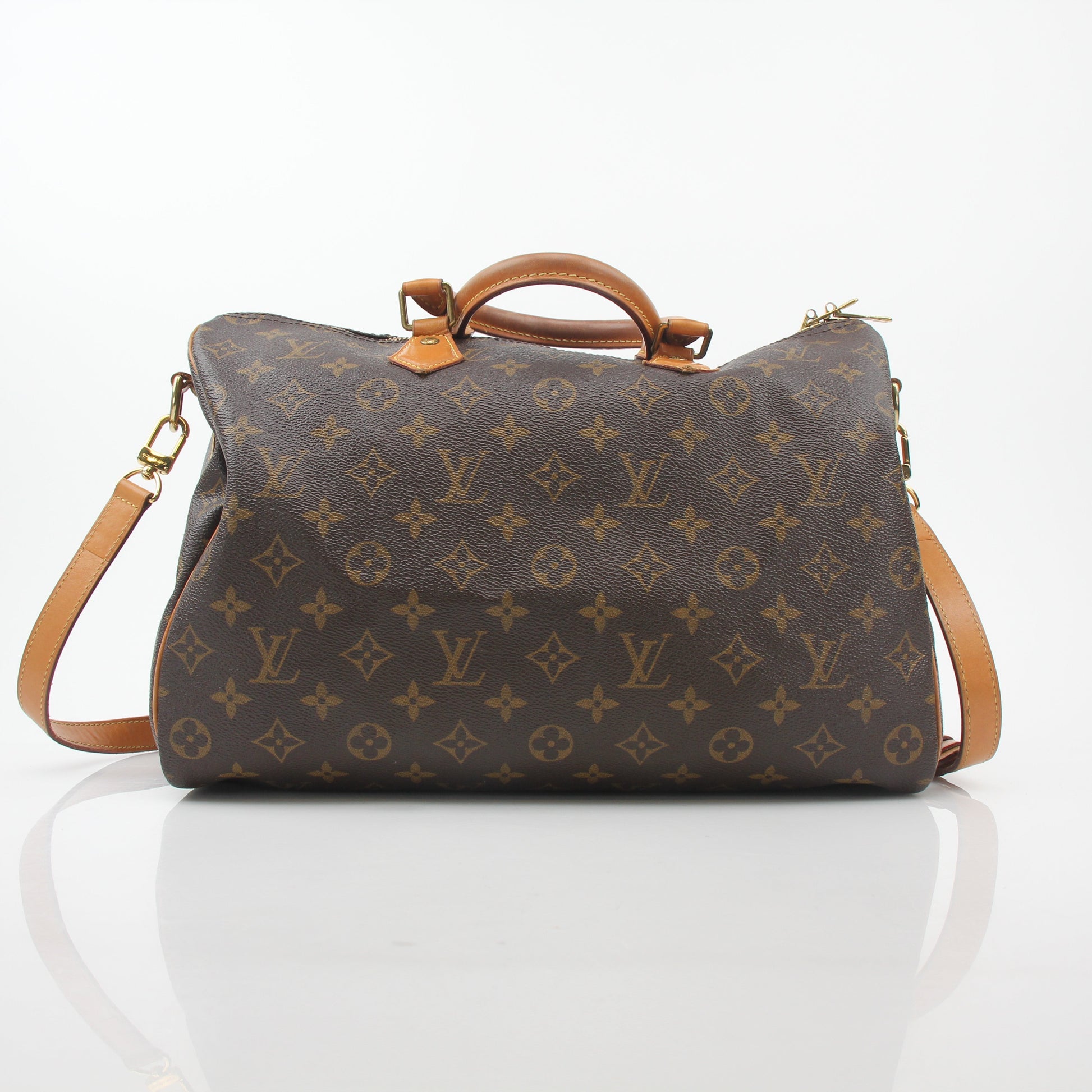 Louis Vuitton Monogram Speedy Bandoulière 35 handbag with leather trim and gold-tone hardware, displayed on a neutral background.