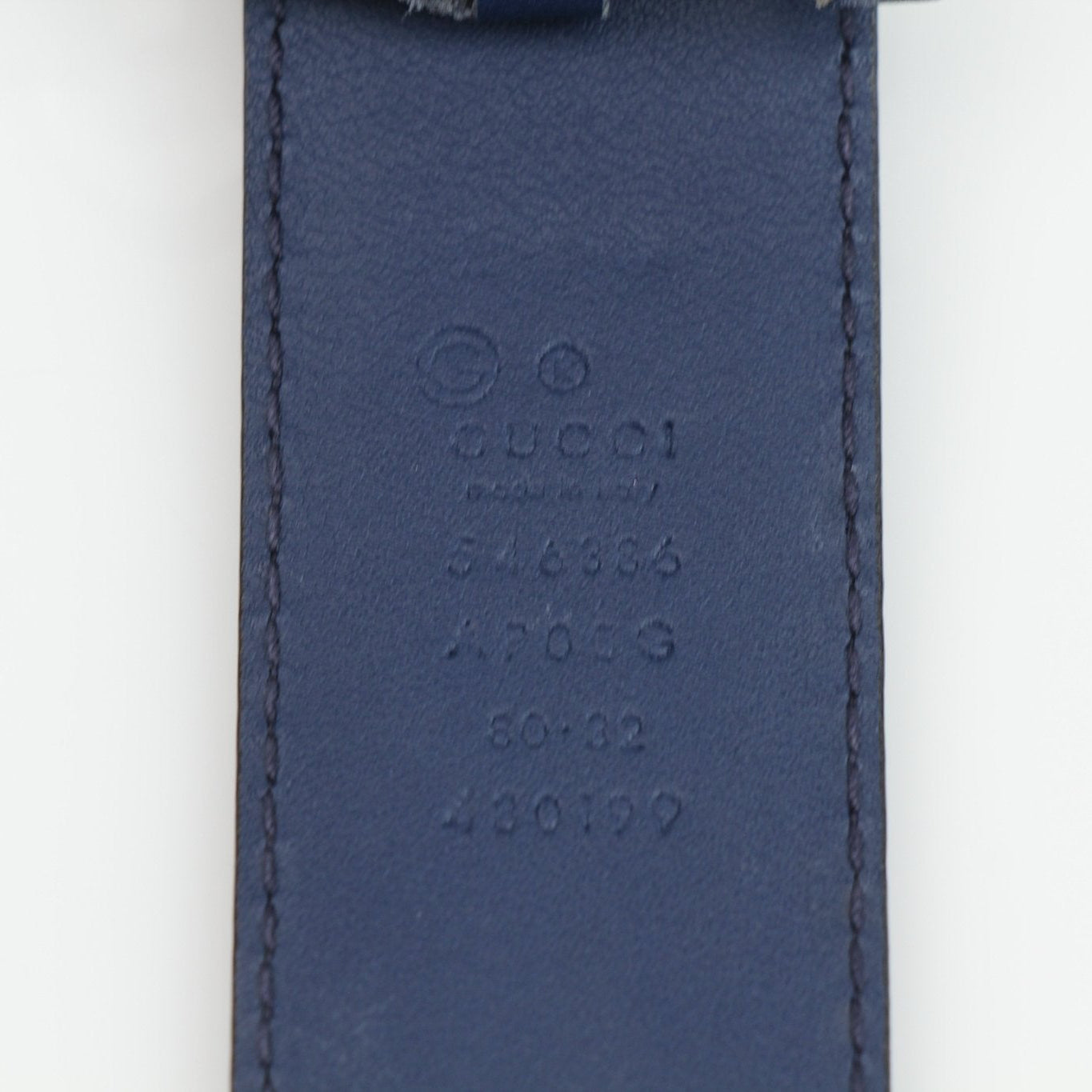 Gucci navy Interlocking GG belt with gold buckle, stylish accessories for men and women, featuring signature branding and high-quality leather.
