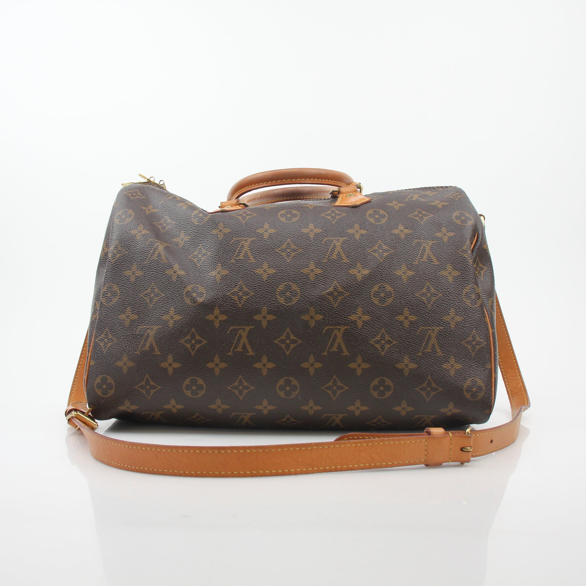 Louis Vuitton Monogram Speedy Bandoulière 35 handbag with leather trim and gold hardware, displayed on a neutral background.