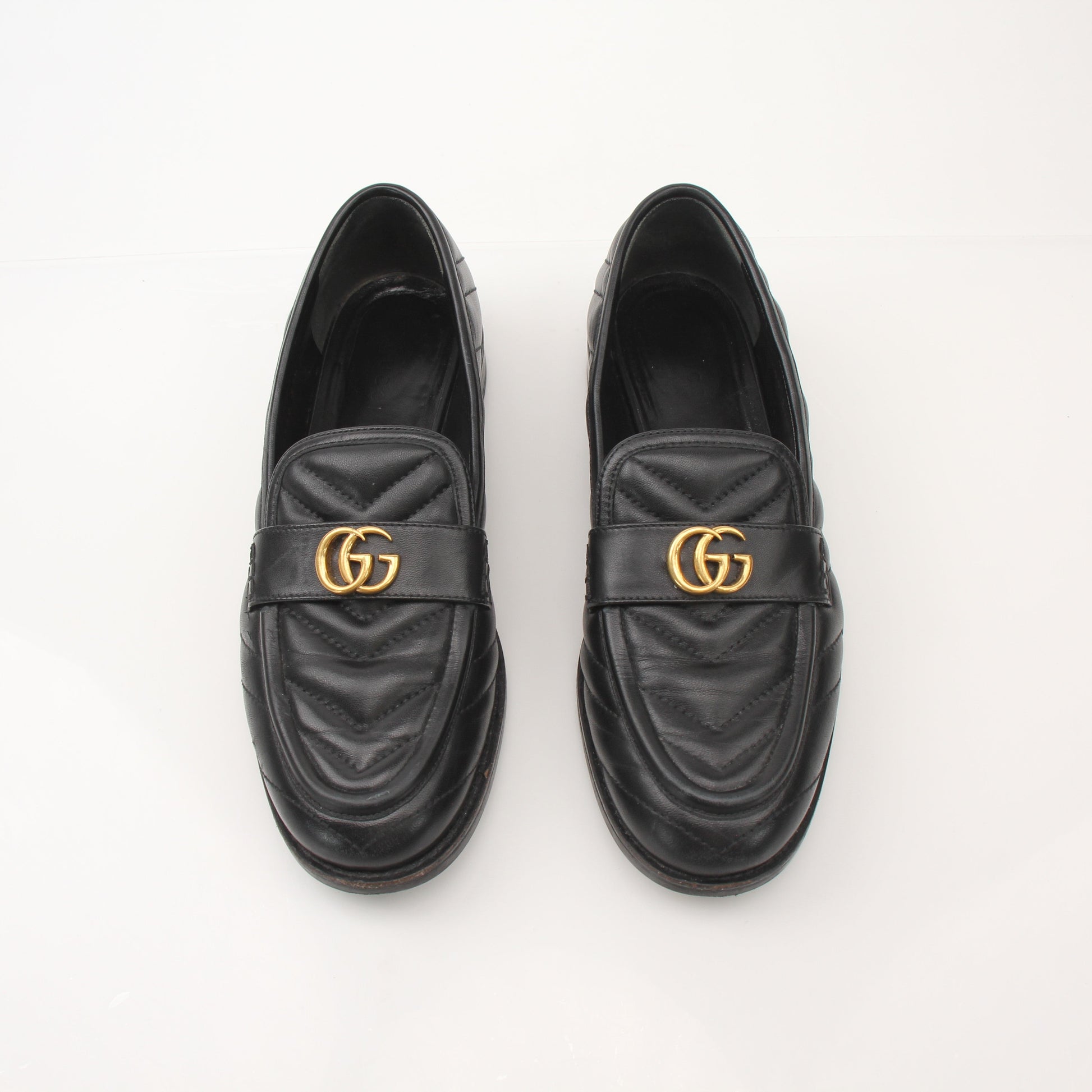 Gold & Beyond Gucci women's double G loafers, stylish leather shoes featuring iconic GG logo and classic slip-on design.