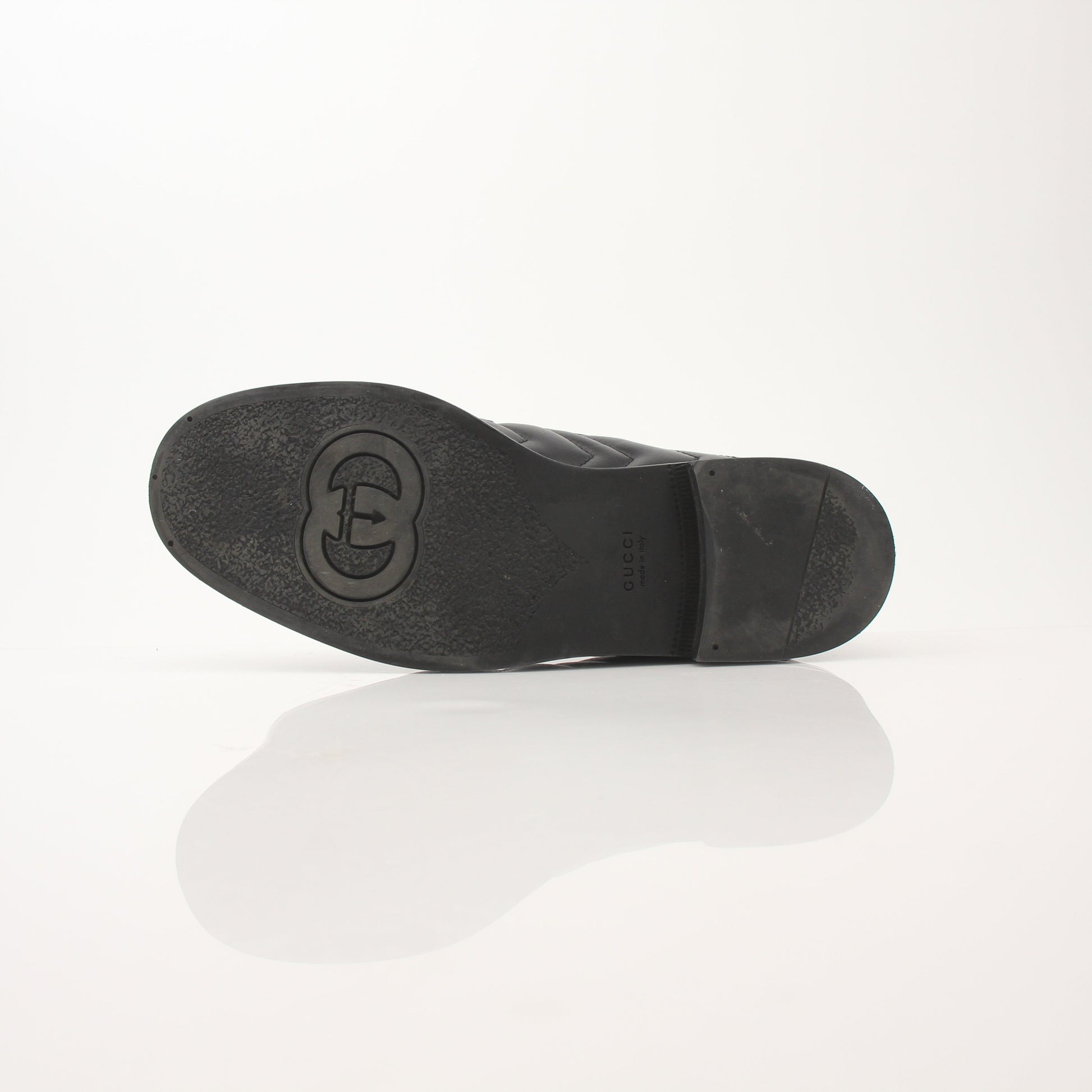 Gold & Beyond Gucci women's double G loafers, stylish leather shoes with iconic logo detailing, on a neutral background.