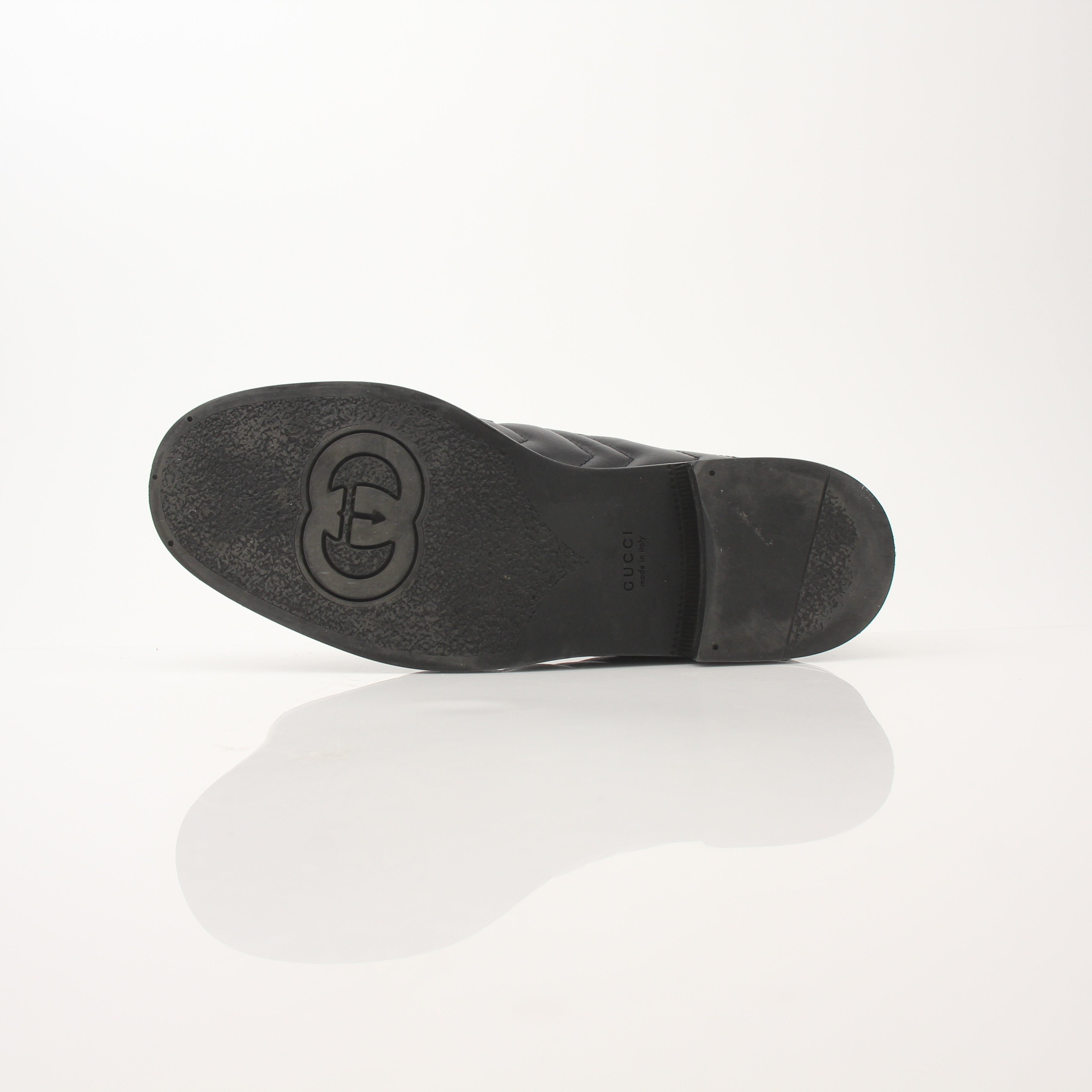 Gold & Beyond Gucci women's double G loafers, stylish leather shoes with iconic logo detailing, on a neutral background.