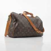 Louis Vuitton Monogram Speedy Bandoulière 35 handbag with leather handles and gold hardware, displayed on a plain background.