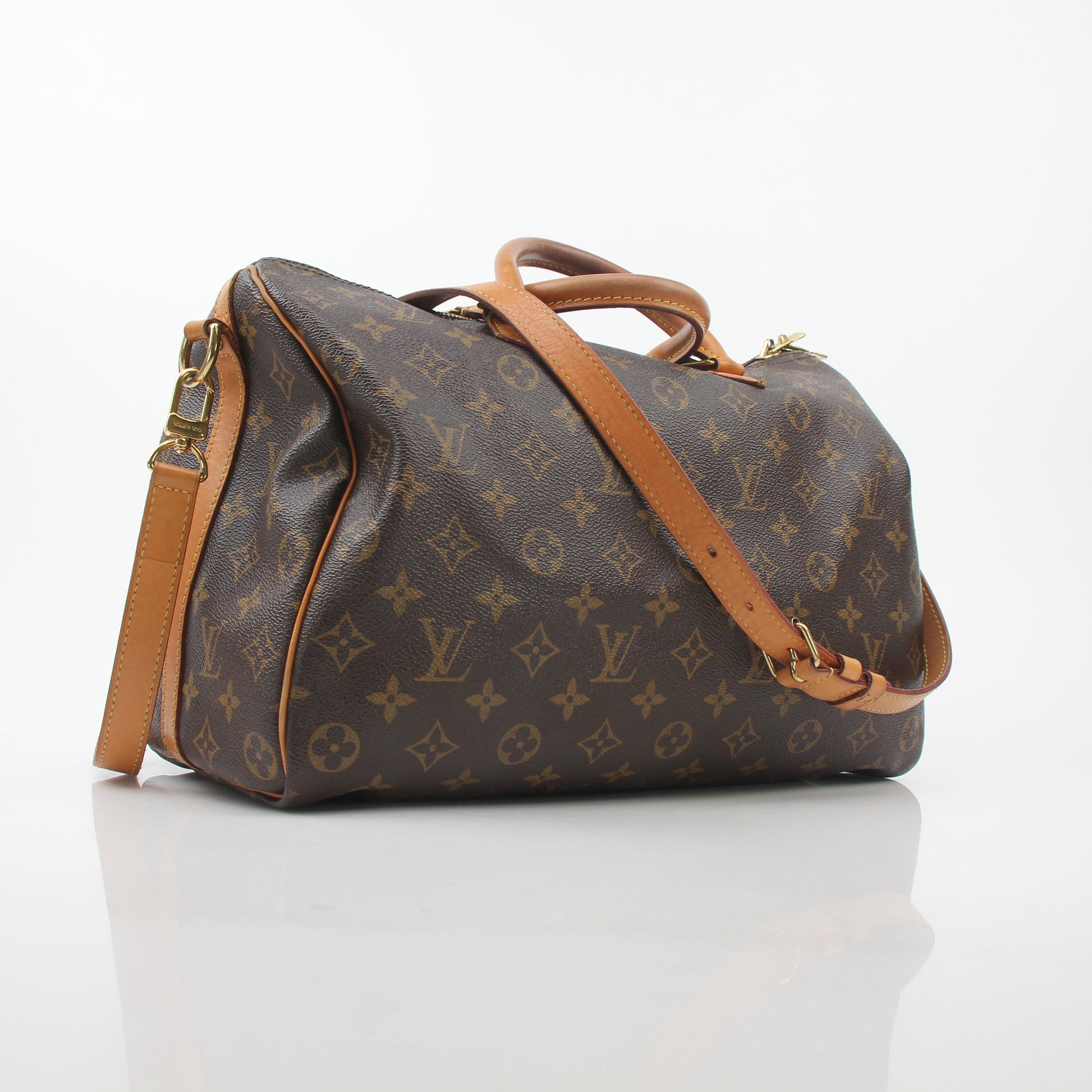 Louis Vuitton Monogram Speedy Bandoulière 35 handbag with leather handles and gold hardware, displayed on a plain background.