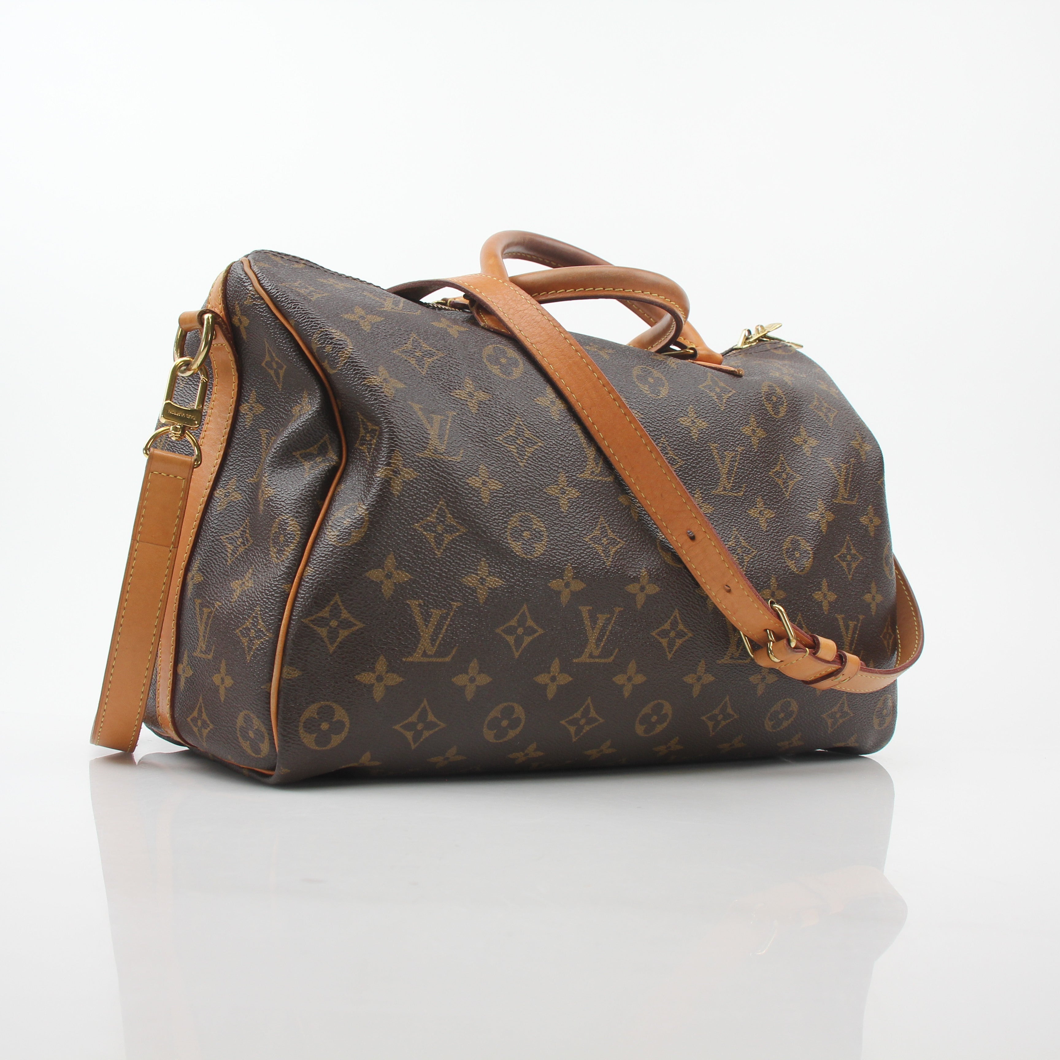 Louis Vuitton Monogram Speedy Bandoulière 35 handbag with leather handles and gold hardware, displayed on a plain background.