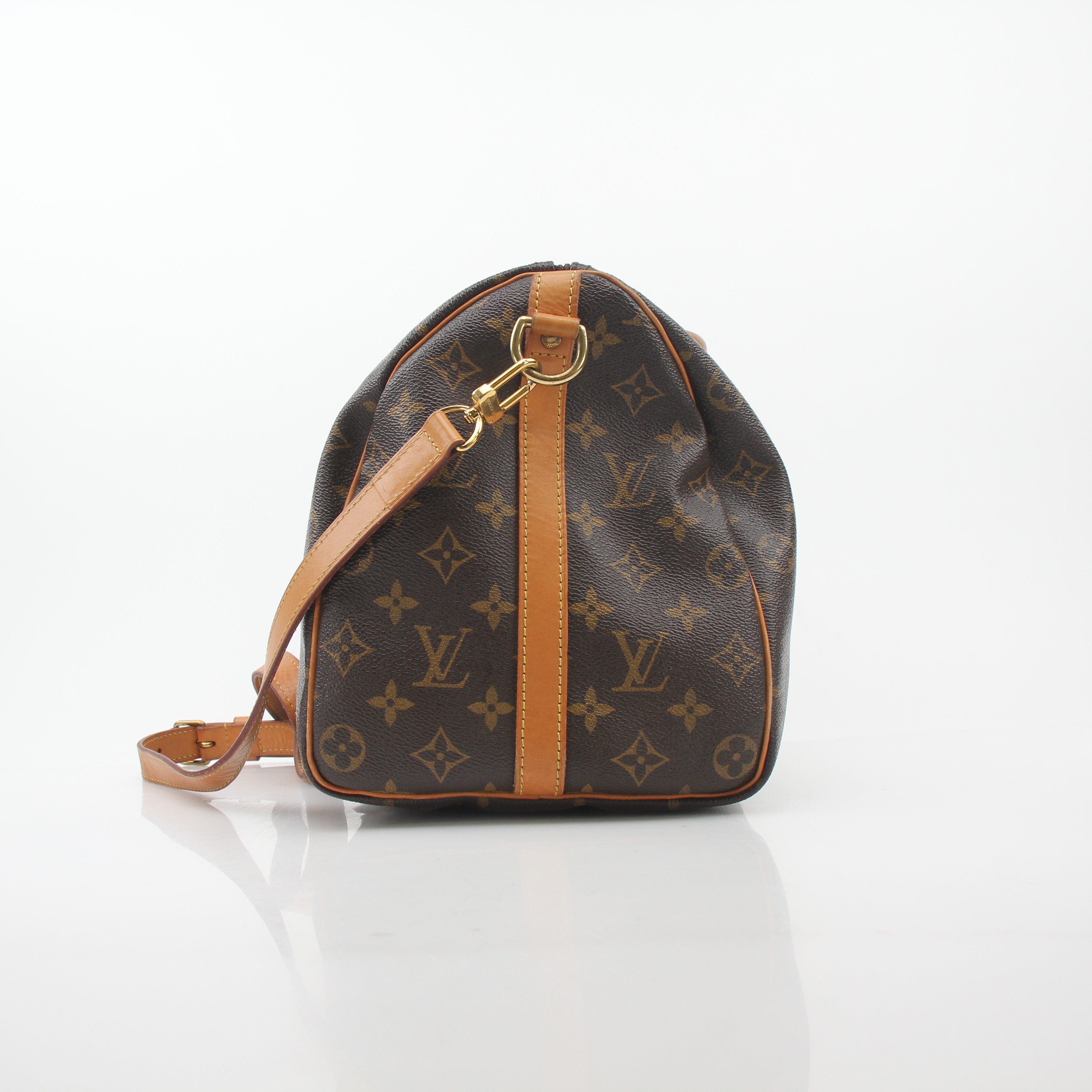 Louis Vuitton Monogram Speedy Bandoulière 35 handbag with leather trim and gold hardware, showcased on a plain background.