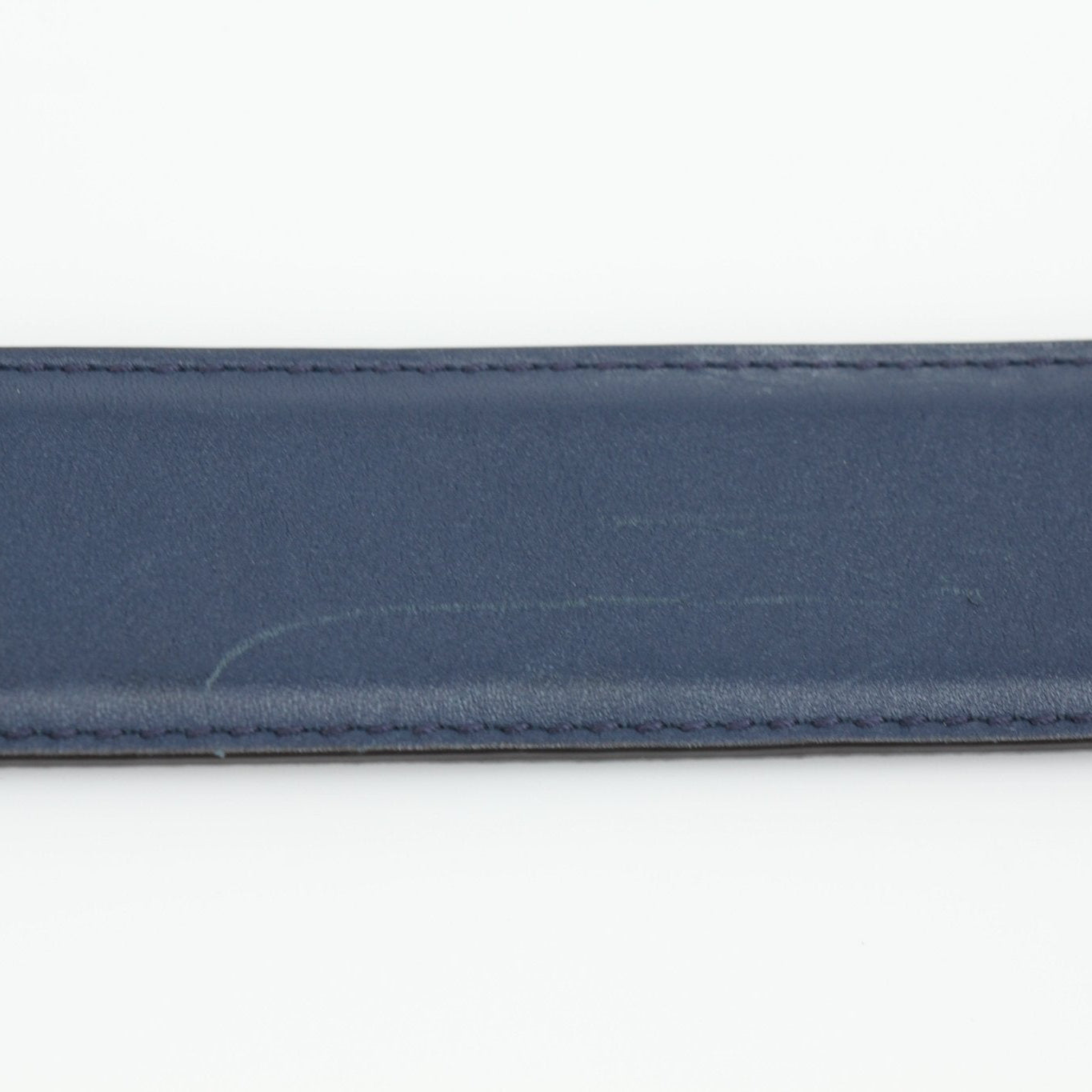 Navy Gucci Interlocking GG belt with gold buckle, stylish accessories for men and women, shown on a plain background.