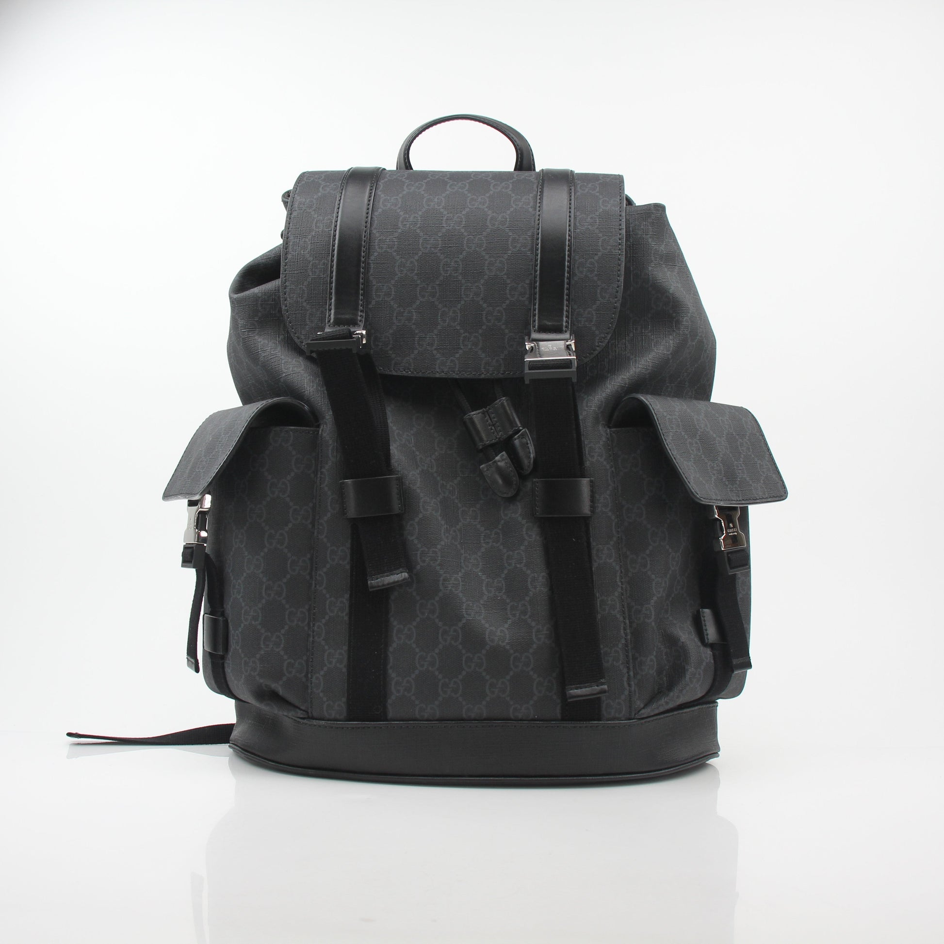 Gucci Black GG Supreme Lark Backpack, a stylish travel bag with gold accents and adjustable straps, showcasing the iconic pattern.
