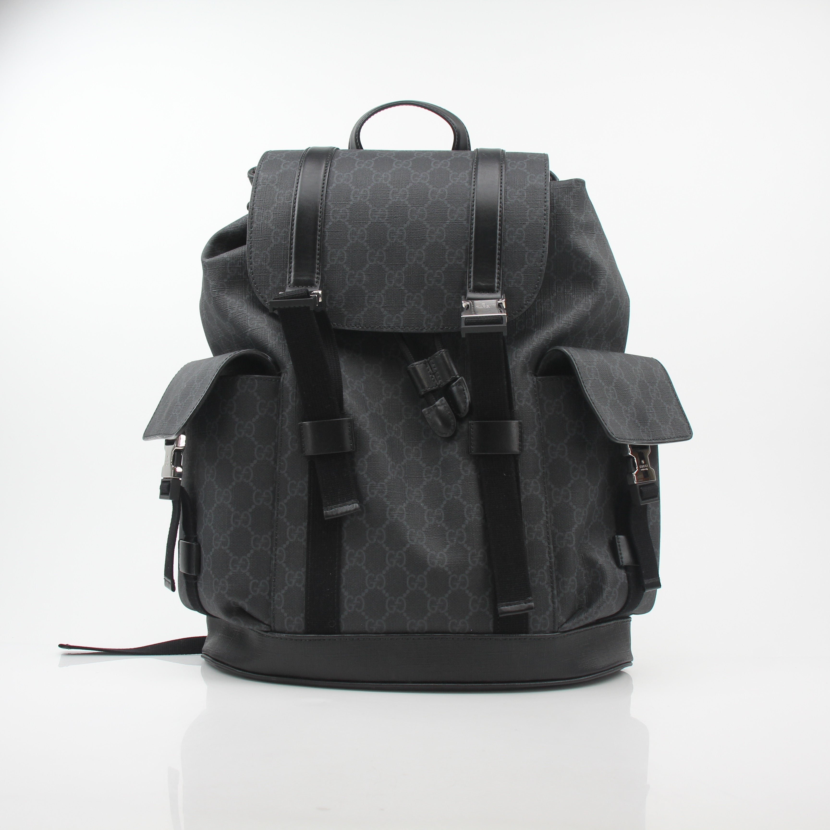 Gucci Black GG Supreme Lark Backpack, a stylish travel bag with gold accents and adjustable straps, showcasing the iconic pattern.