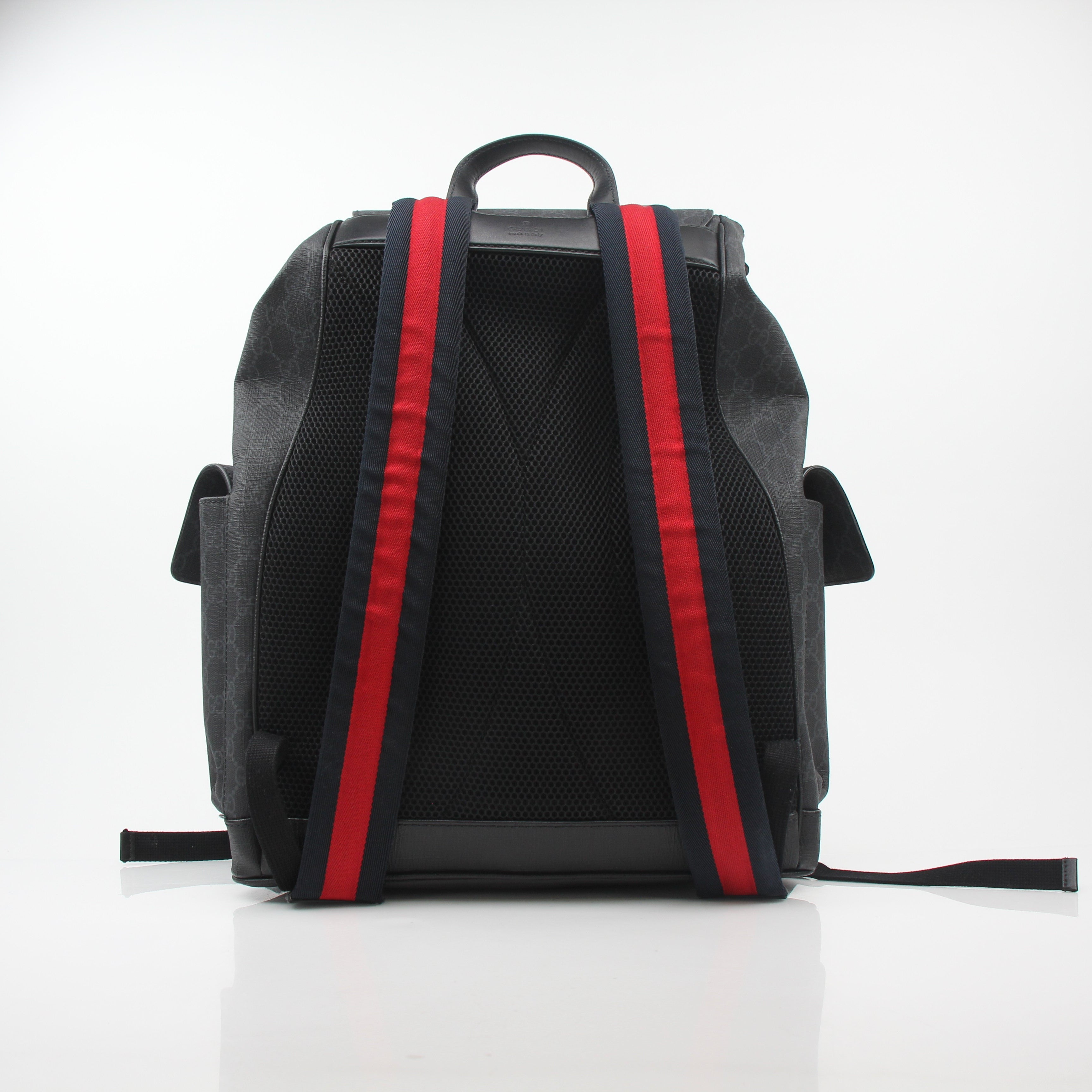 Gucci black GG Supreme Lark backpack, stylish travel bag with leather accents, displayed on a plain background.