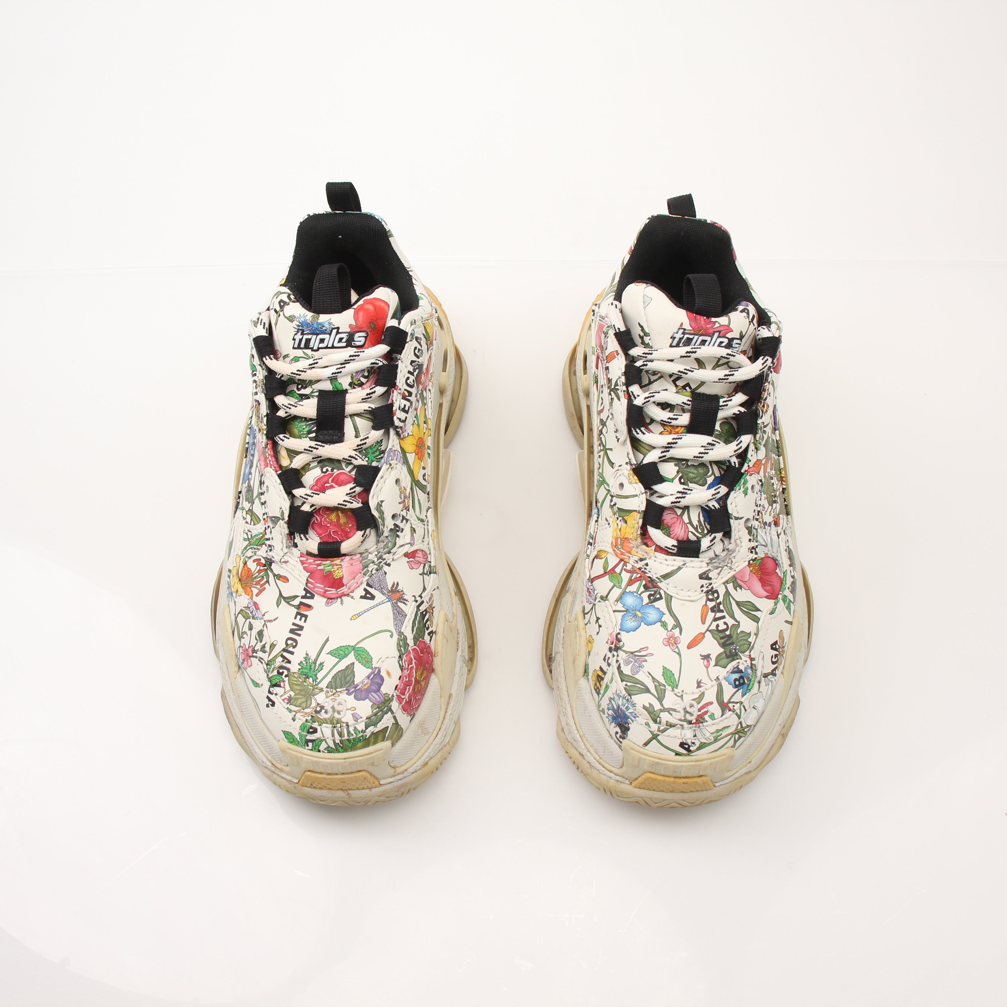 Gucci x Balenciaga The Hacker Project Triple S Sneakers in gold and black, featuring chunky design and mixed brand logos.
