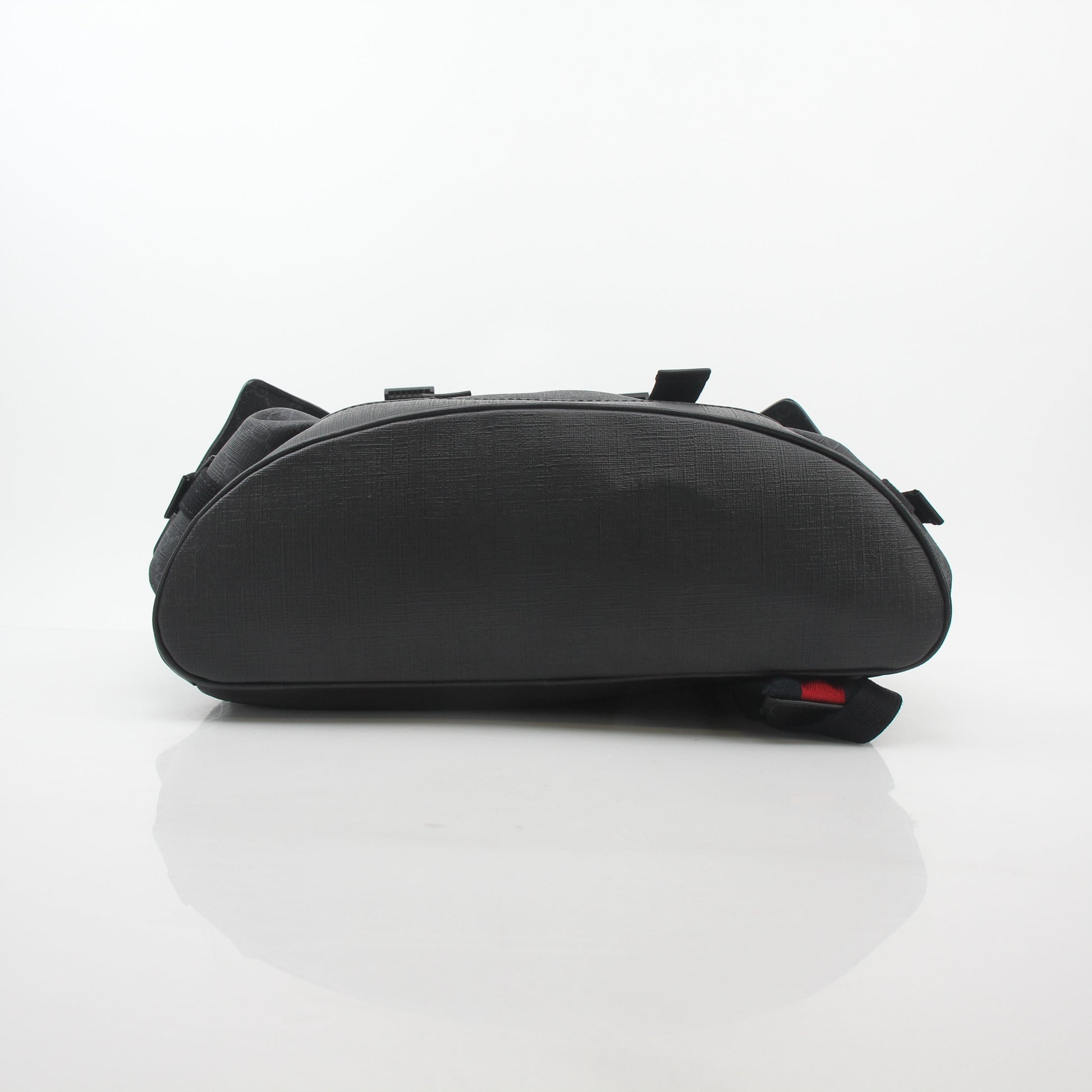 Gucci Black GG Supreme Lark Backpack, a stylish travel bag with signature monogram and leather accents, displayed on a plain background.