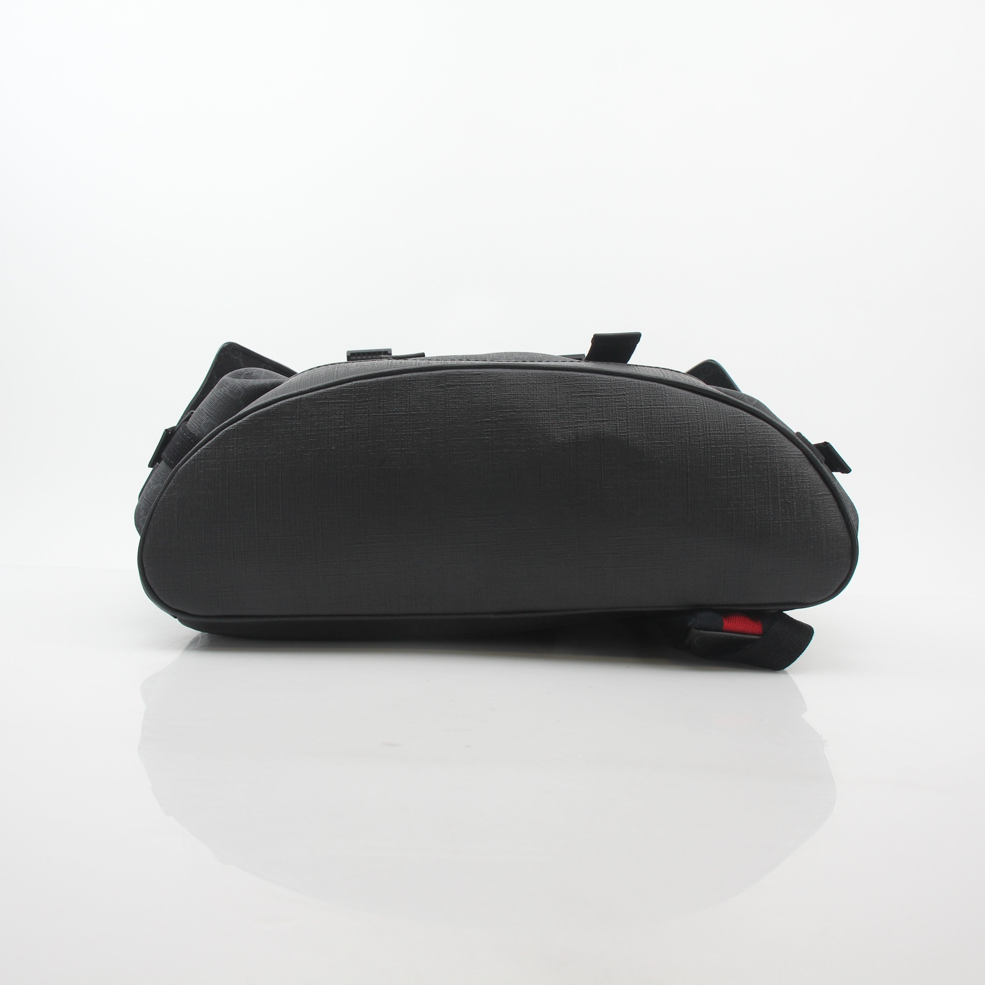 Gucci Black GG Supreme Lark Backpack, a stylish travel bag with signature monogram and leather accents, displayed on a plain background.