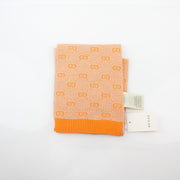 Gucci Tangerine GG Jacquard scarf featuring the iconic pattern, styled as a luxurious accessories piece.