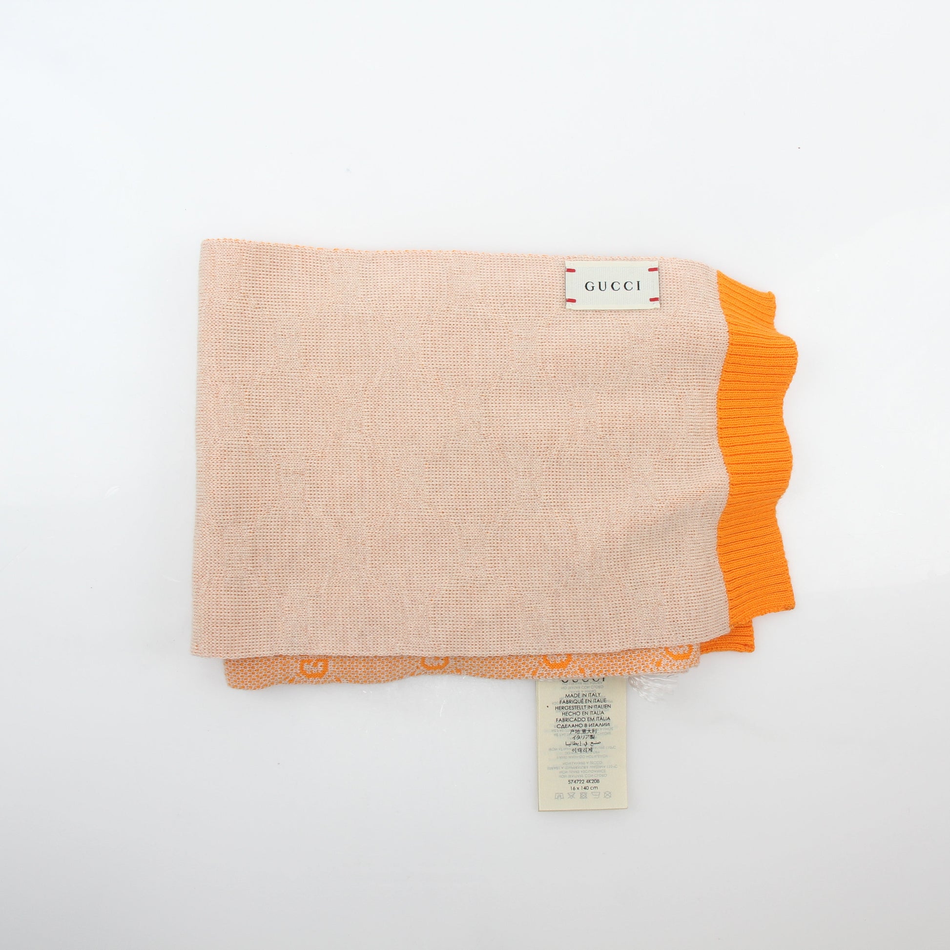 Gucci Tangerine GG Jacquard scarf, luxury accessories featuring iconic pattern, displayed flat with fringed edges.