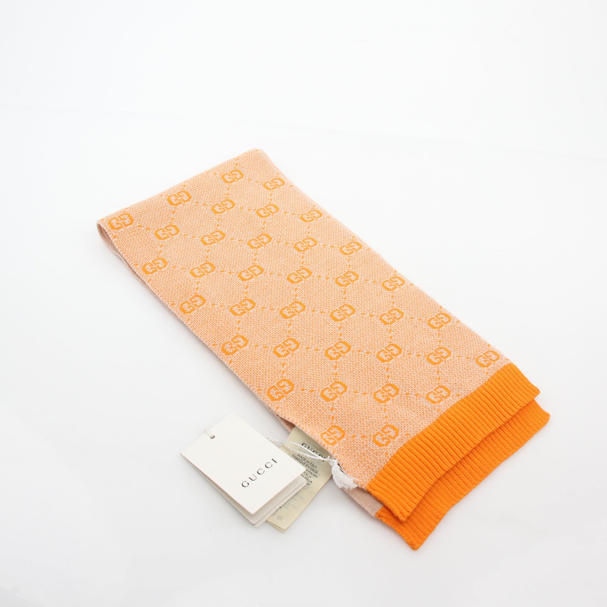 Gucci Tangerine GG Jacquard scarf, gold and beyond accessories, showcasing vibrant orange patterned silk fabric.
