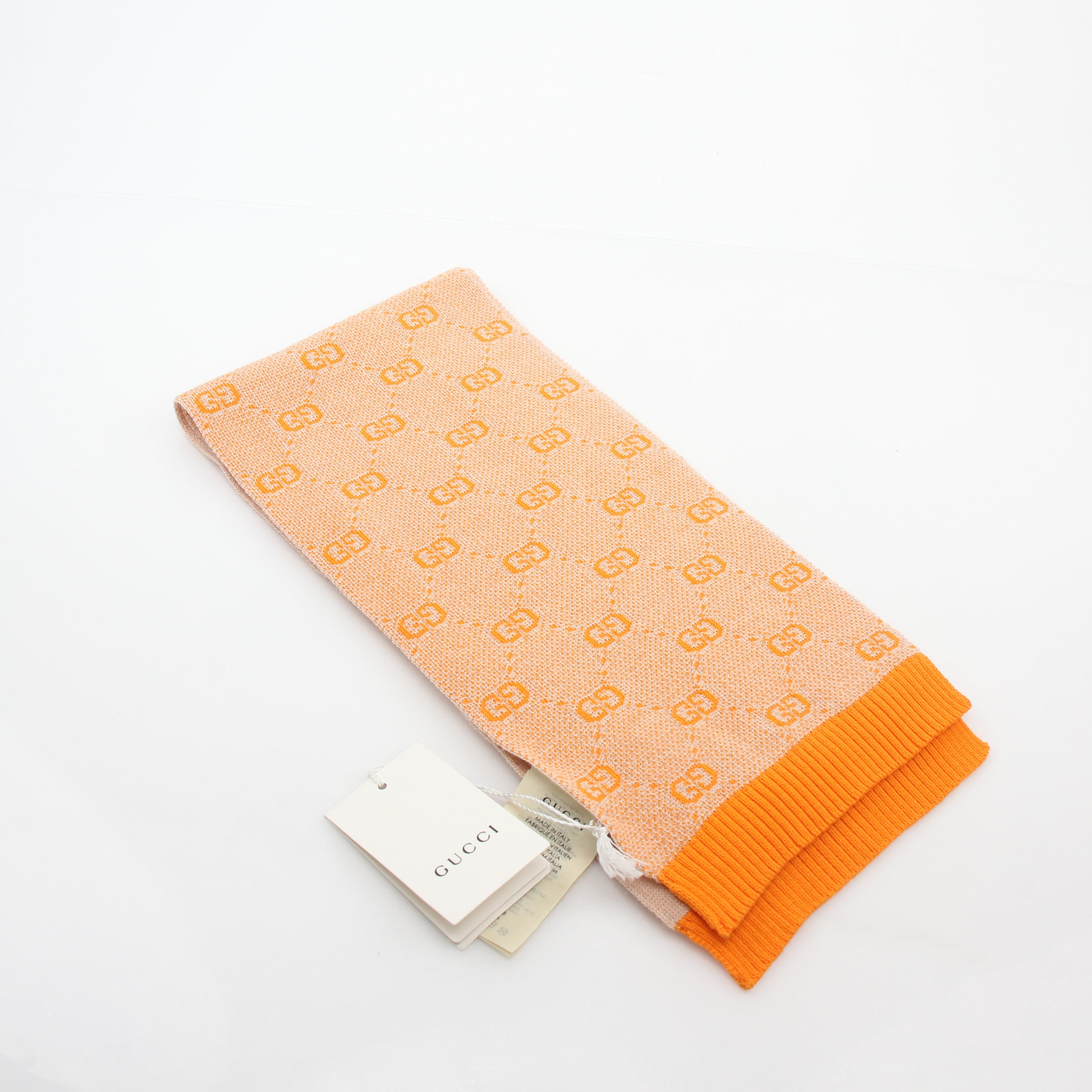 Gucci Tangerine GG Jacquard scarf, gold and beyond accessories, showcasing vibrant orange patterned silk fabric.