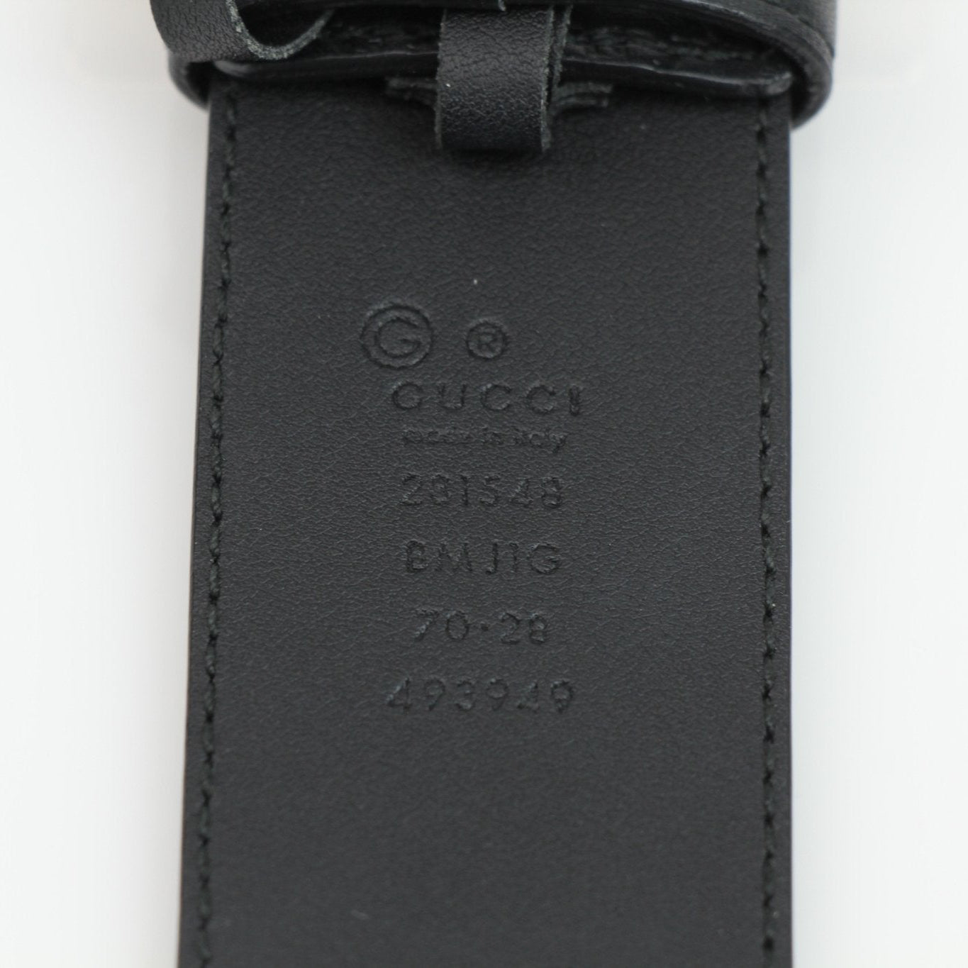 Black Gucci Guccissima belt with gold hardware, showcasing the signature embossed pattern and sleek design for stylish accessories.