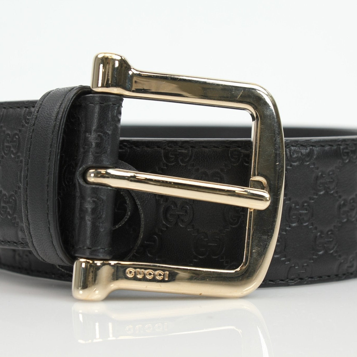Black Gucci Guccissima belt with gold-tone buckle, showcasing luxury leather accessories from Gold & Beyond.