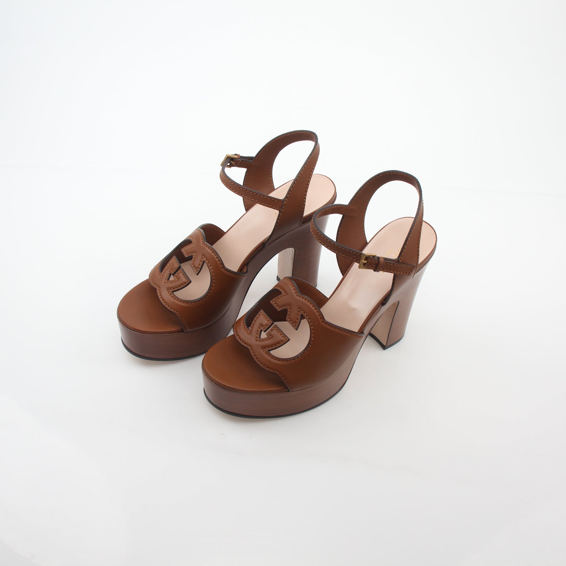 Gold & Beyond Gucci brown interlocking G cut-out platform sandals heels with chunky heel and open toe design.