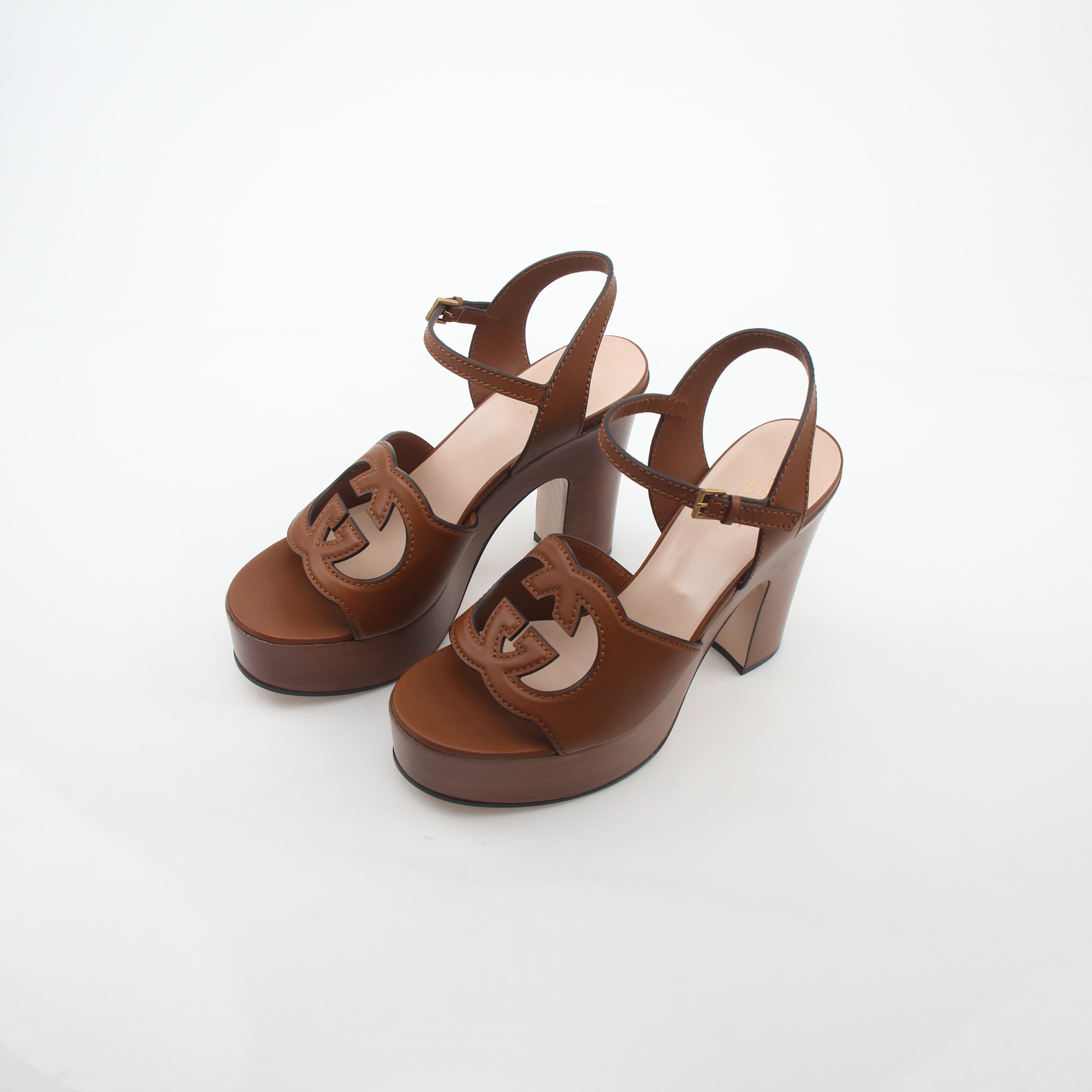 Gold & Beyond Gucci brown interlocking G cut-out platform sandals heels with chunky heel and open toe design.