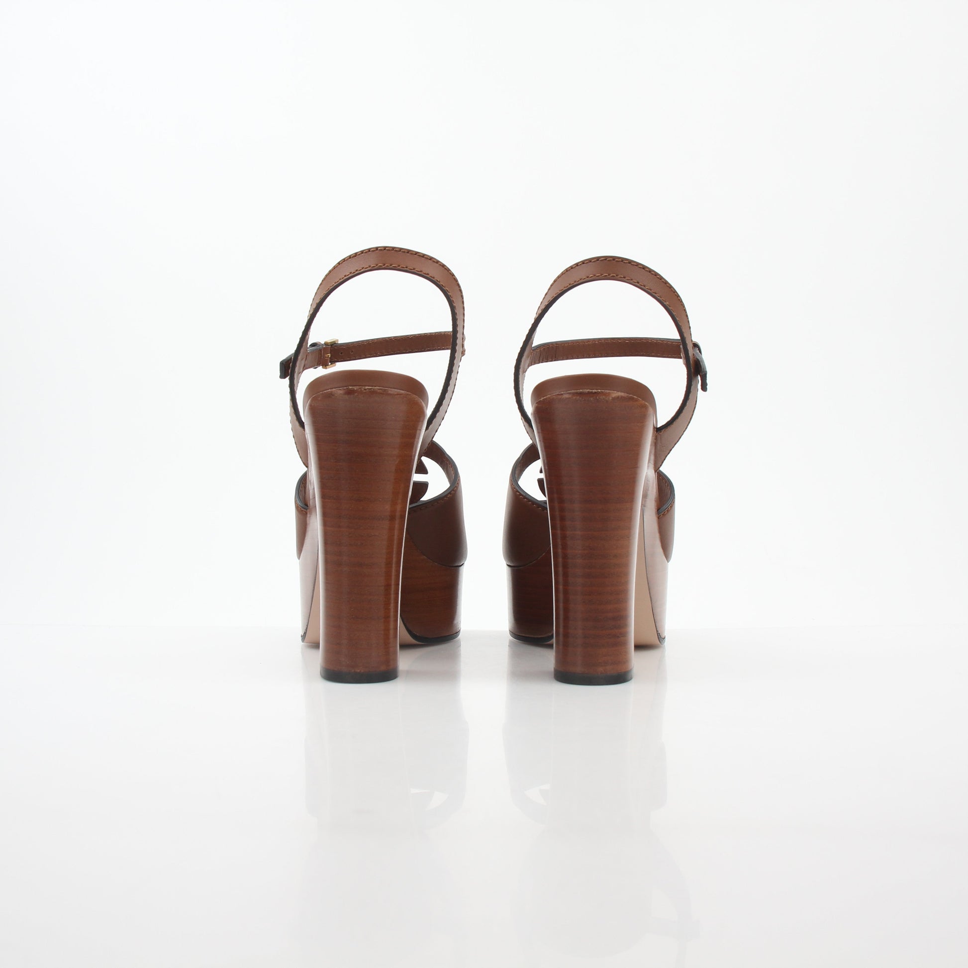 Gold & Beyond Gucci brown interlocking G cut-out platform heels with open toe and ankle strap, stylish and bold footwear.
